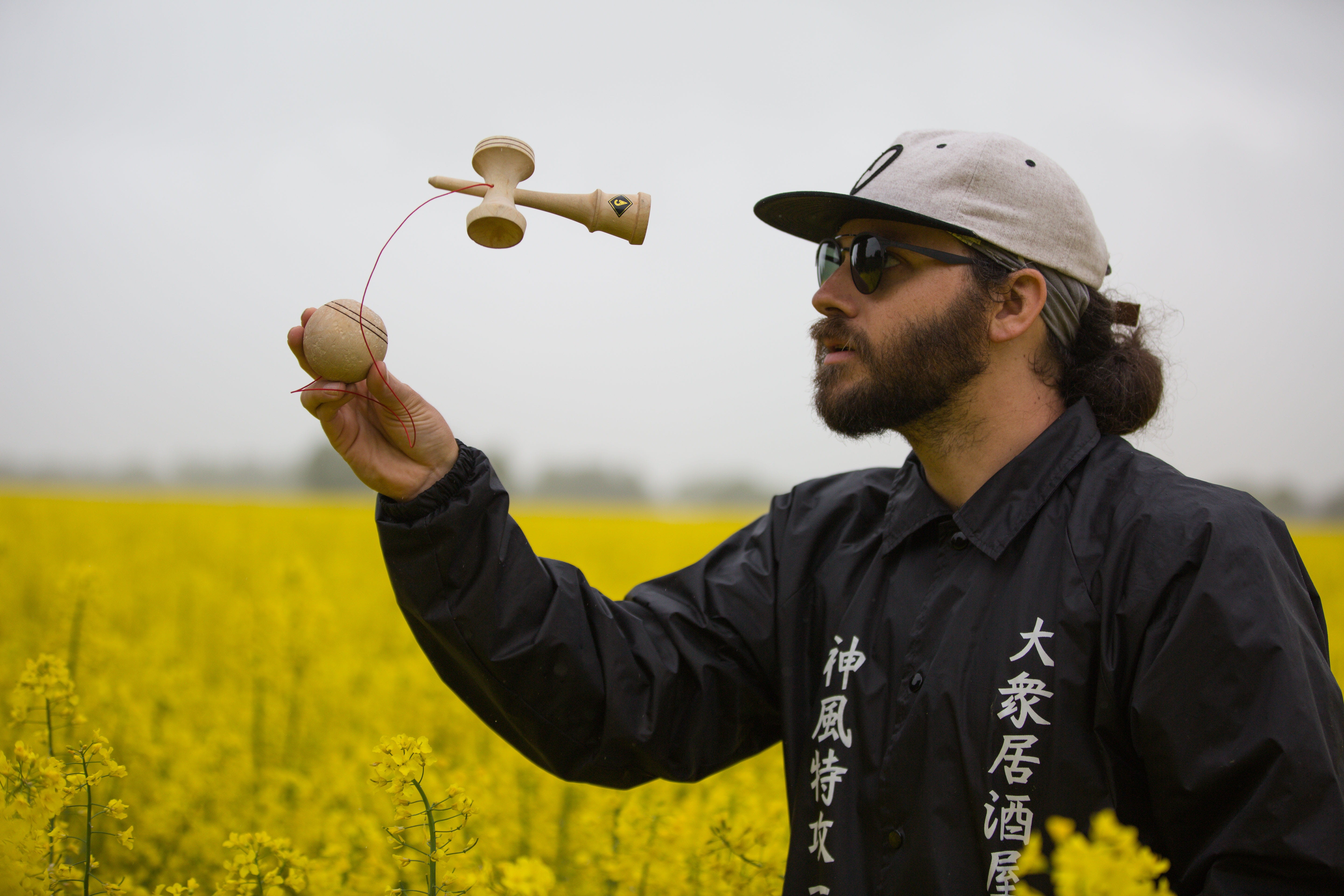 toy, mid adult, one person, japanese skill toy, travel, waist up, kendama, game, mature men, flower field, men, plant, beard, flowers, 5K, yellow, kandama, HD Wallpaper