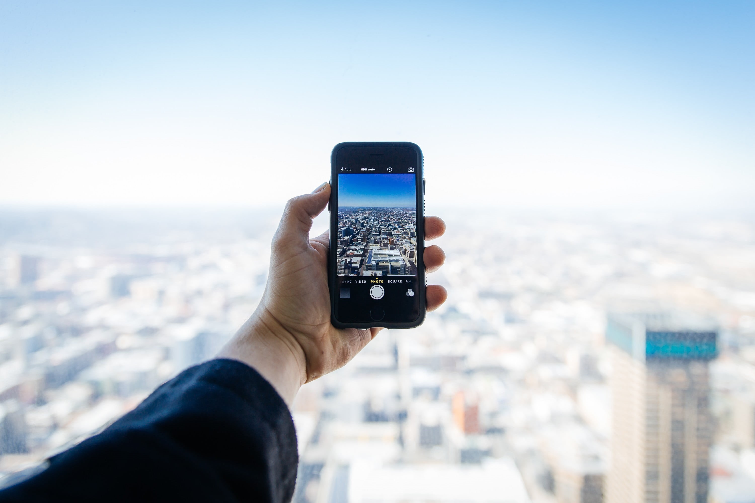 wireless technology, hand, 2K, people, black, one person, human hand, cityscape, smart phone, city, built structure, building exterior, human body part, HD Wallpaper