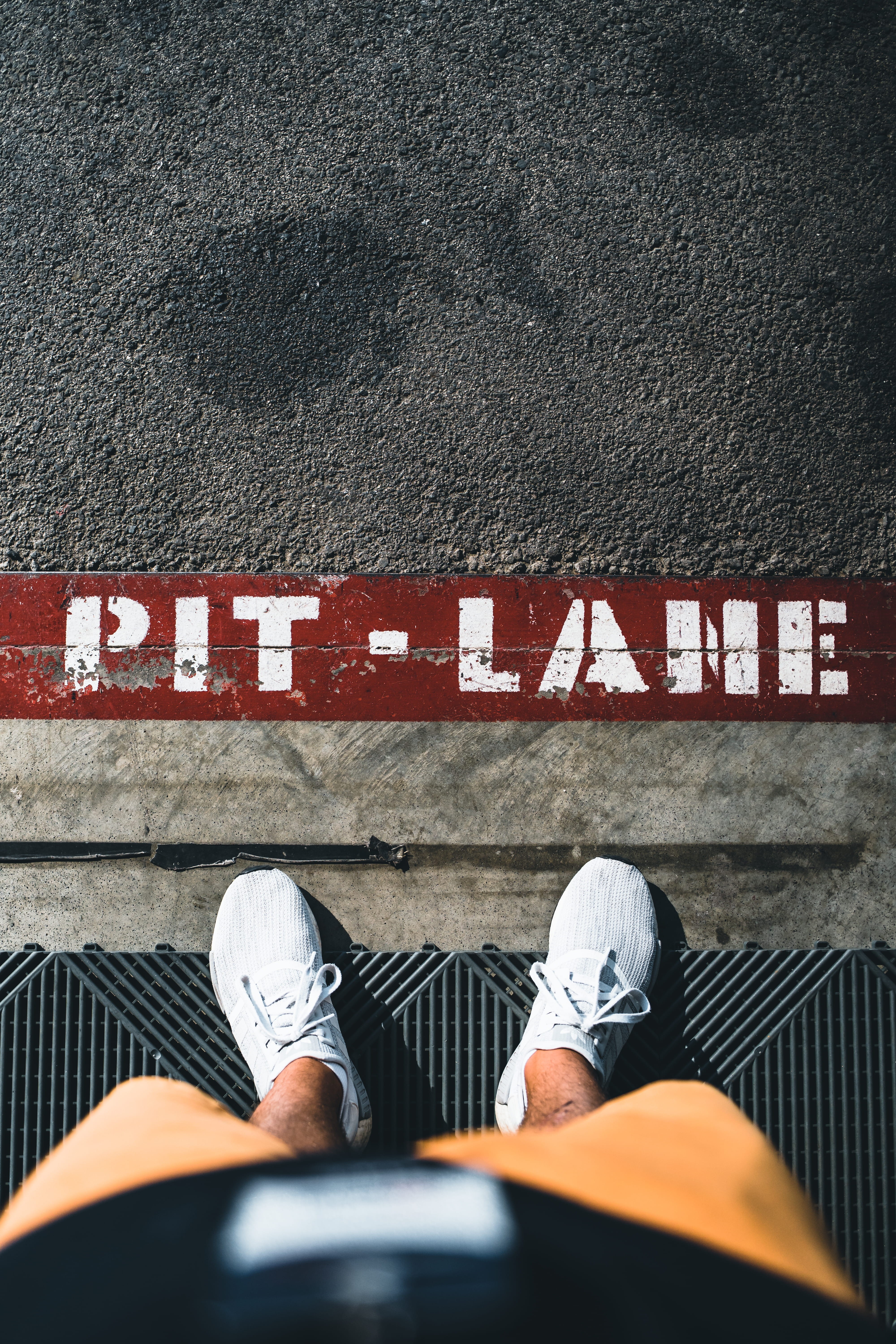human limb, sign, outdoors, day, sneaker, tire, alloy wheel, jeans, human, 5K, running shoe, shoe, asphalt, high angle view, road, real people, human body part, Phone HD Wallpaper