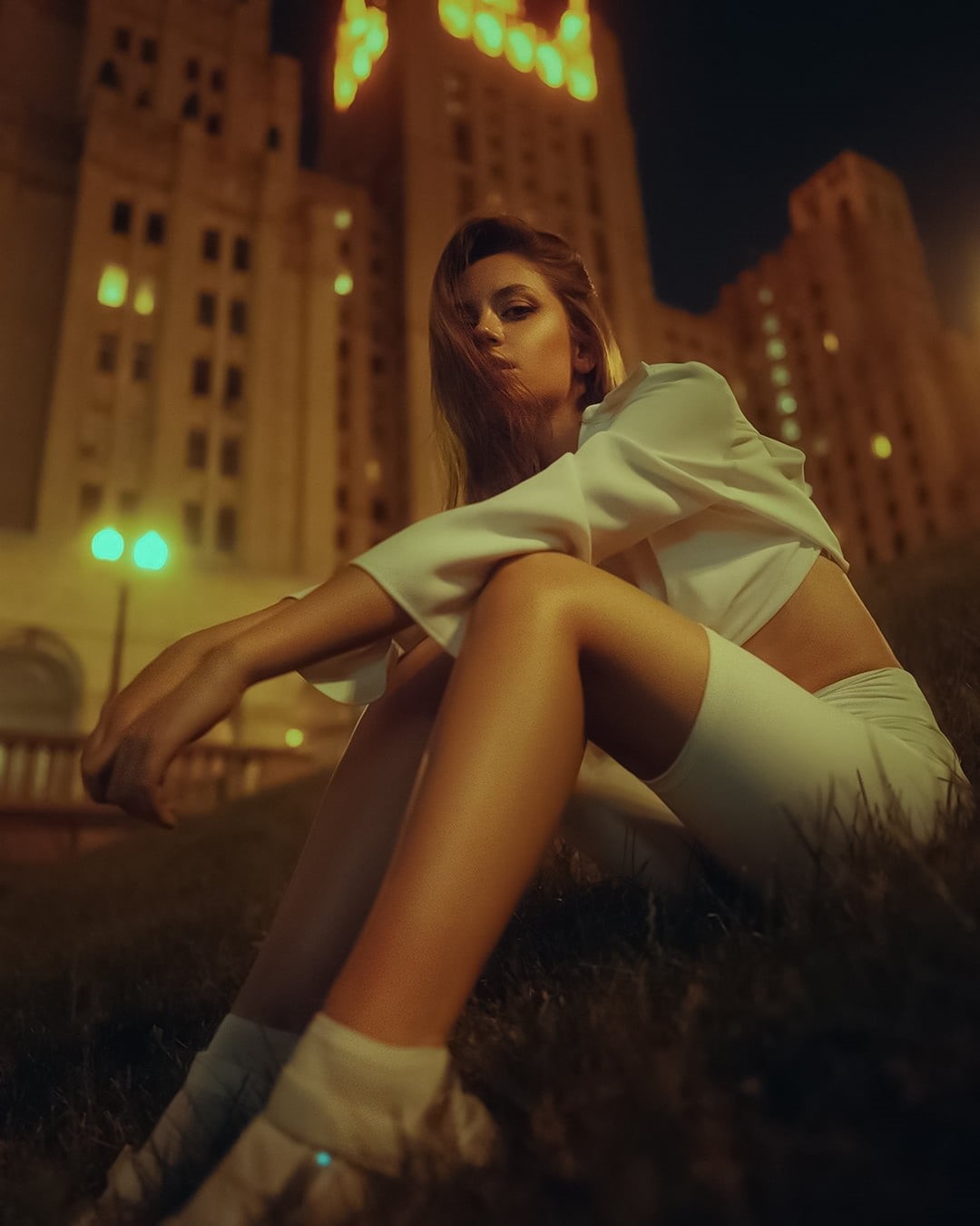grass, Ksenia Kokoreva, city, low-angle, looking at viewer, brunette, 720P, white clothing, legs, hair over one eye, night, Yuriy Lyamin, women, Phone HD Wallpaper