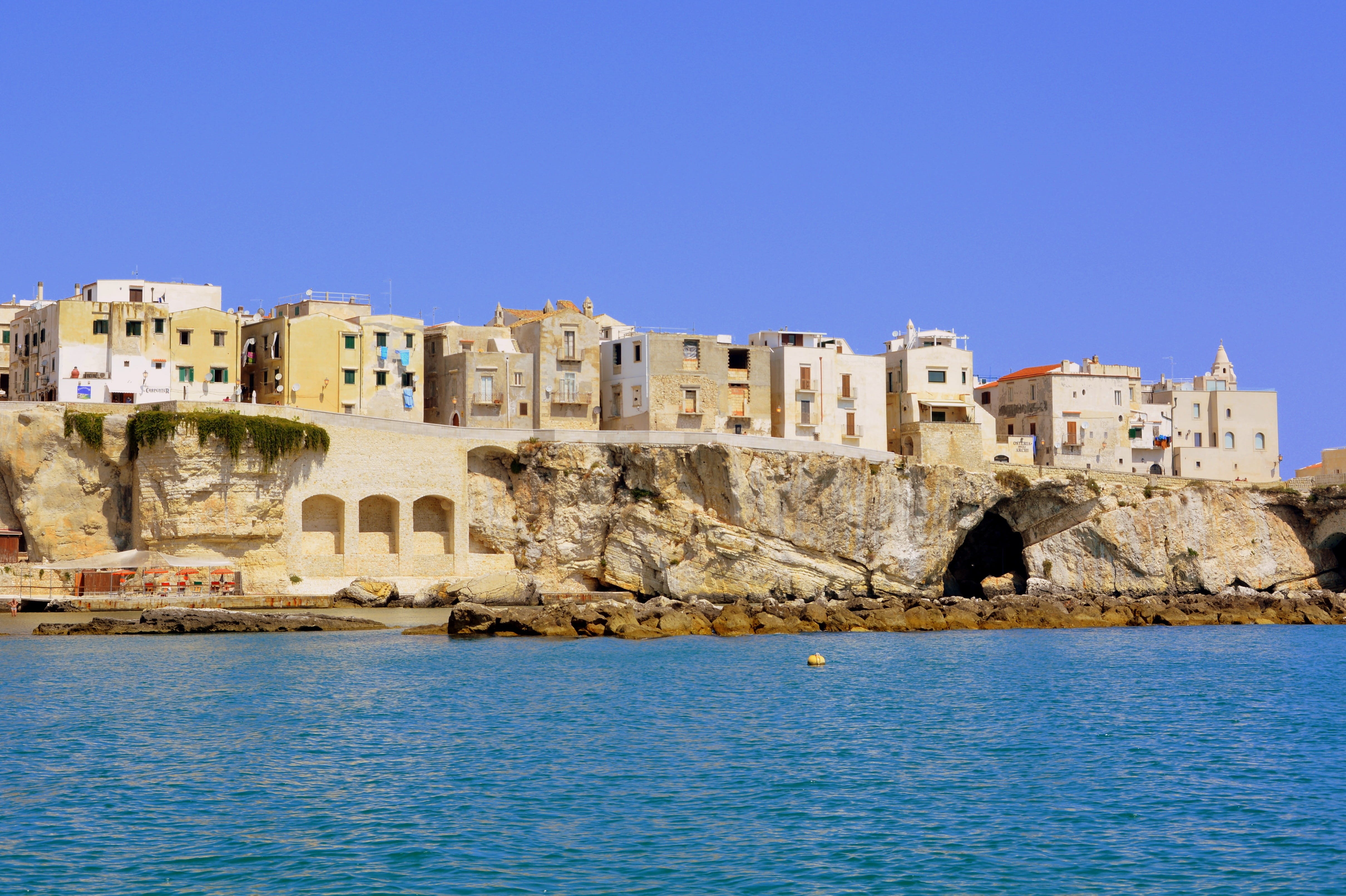 houses, solid, sea, clear sky, the past, architecture, rock - object, fort, built structure, blue, sky, history, land, gargano, outdoors, castle, water, HD Wallpaper