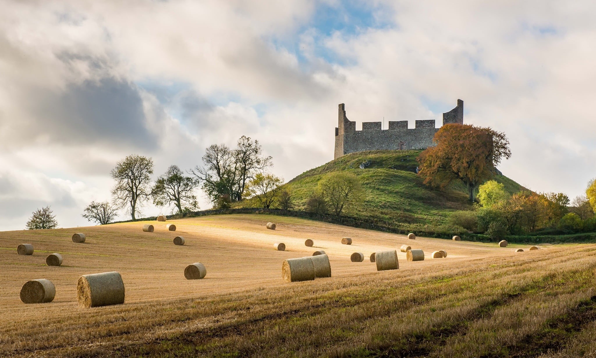 sunlight, trees, architecture, hay, 1080P, sky, yellow, castle, built structure, bale, rural scene, clouds, landscape, grass, nature, hills, land, field, HD Wallpaper