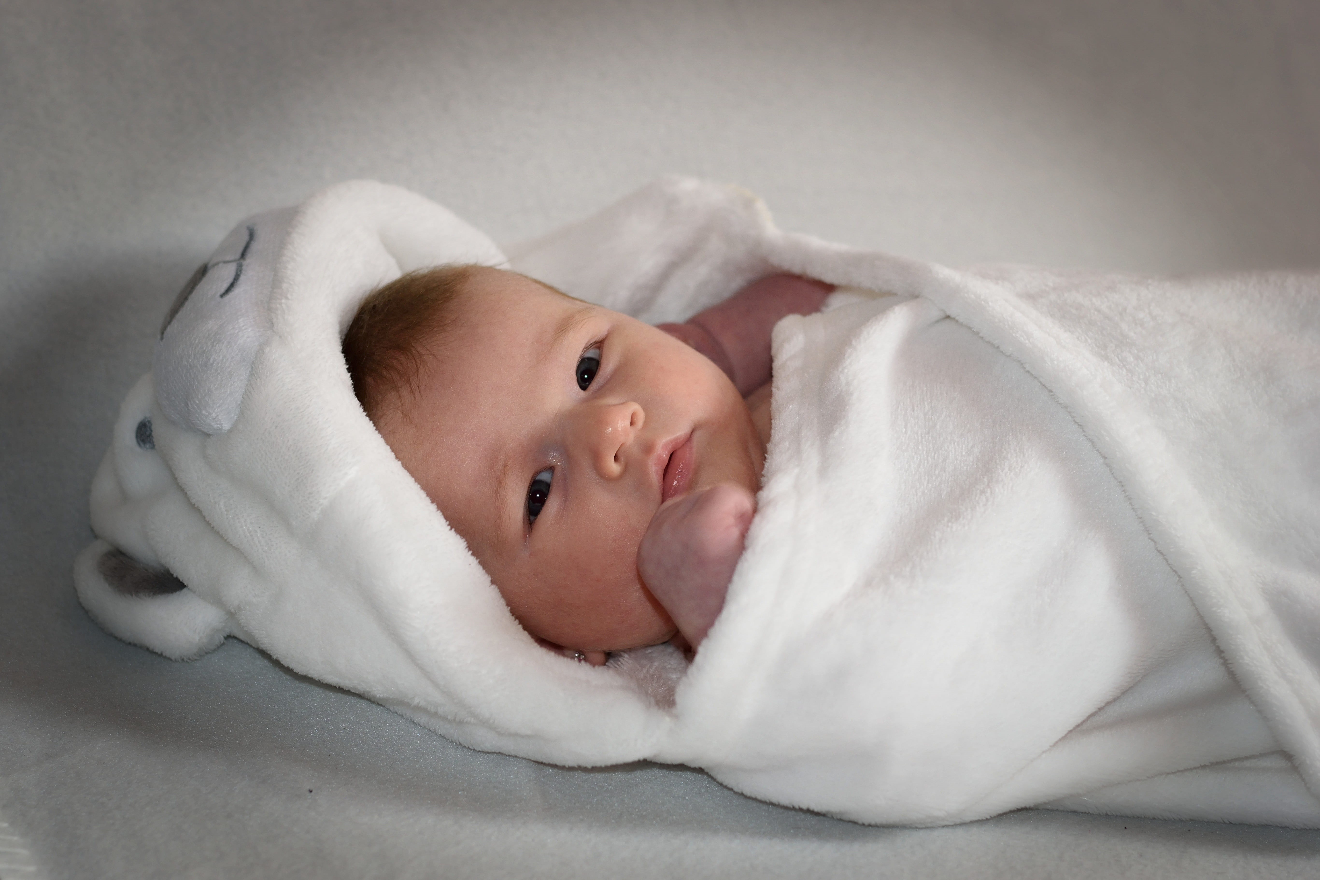 looking at camera, childhood, lying down, relaxation, wrapped in a blanket, innocence, young, portrait, babyhood, mouth open, baby girl, 5K, headshot, HD Wallpaper
