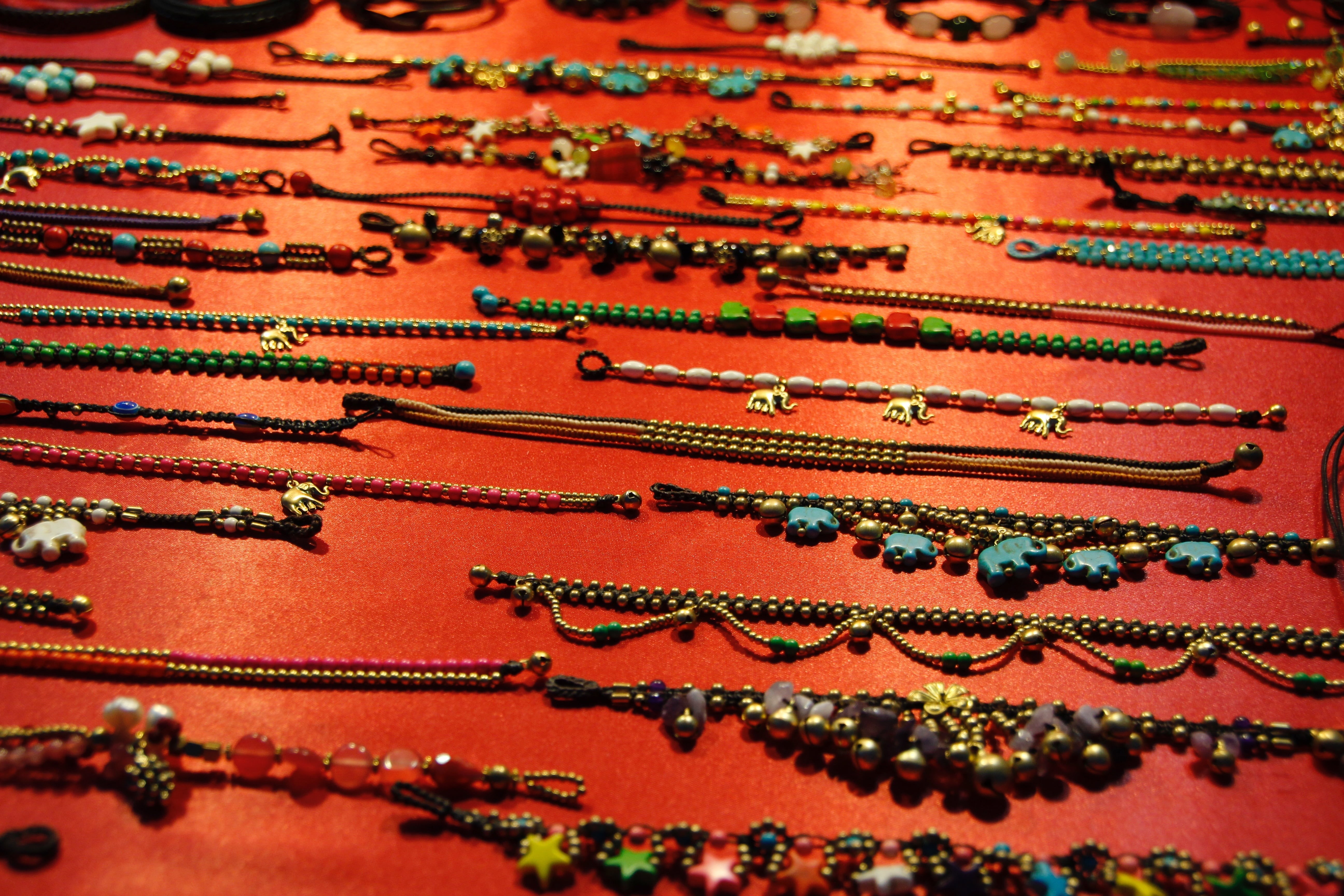 5K, shiny, rhinestone, beads, high angle view, close-up, carpet - decor, anklet, metal, brass, backgrounds, red, wood beads, industry, art and craft, selective focus, HD Wallpaper