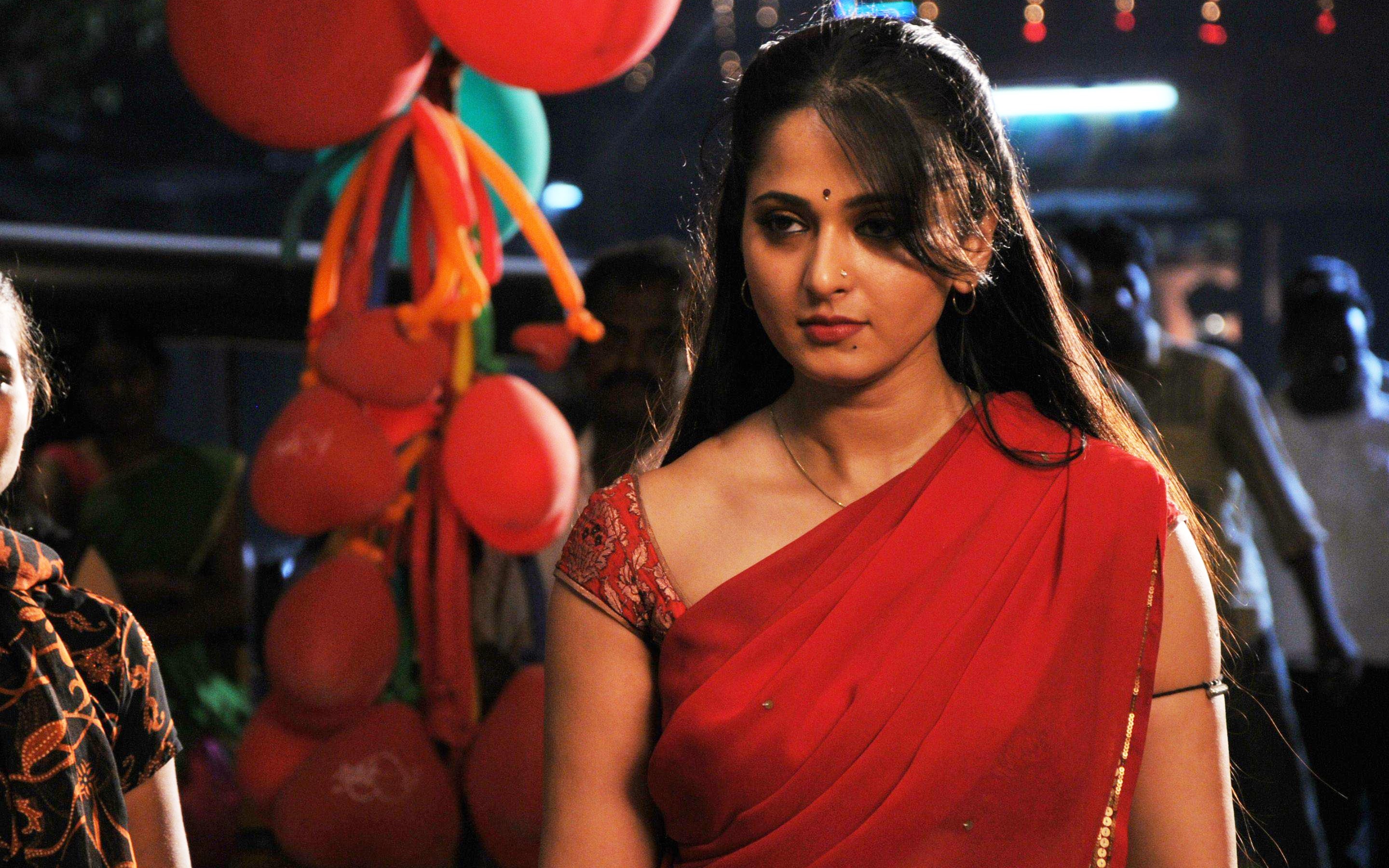 Vaanam, focus on foreground, women, Anushka, 2K, beautiful woman, incidental people, lifestyles, red, portrait, night, waist up, real people, young women, HD Wallpaper