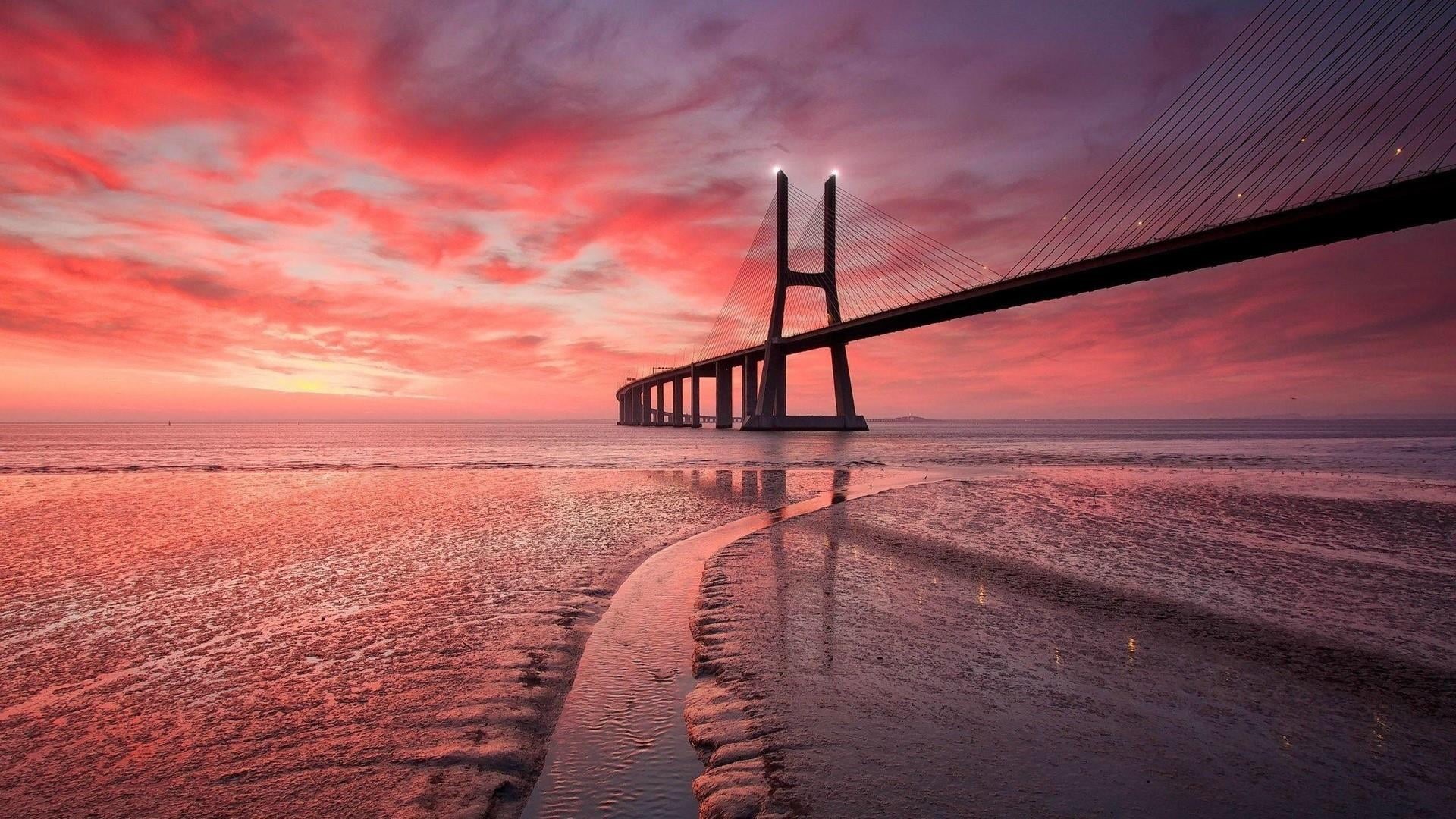 built structure, vasco da gama bridge, shore, water, horizon over water, sky, low tide, europe, bridge - man made structure, pink sky, calm, beach, sea, HD Wallpaper