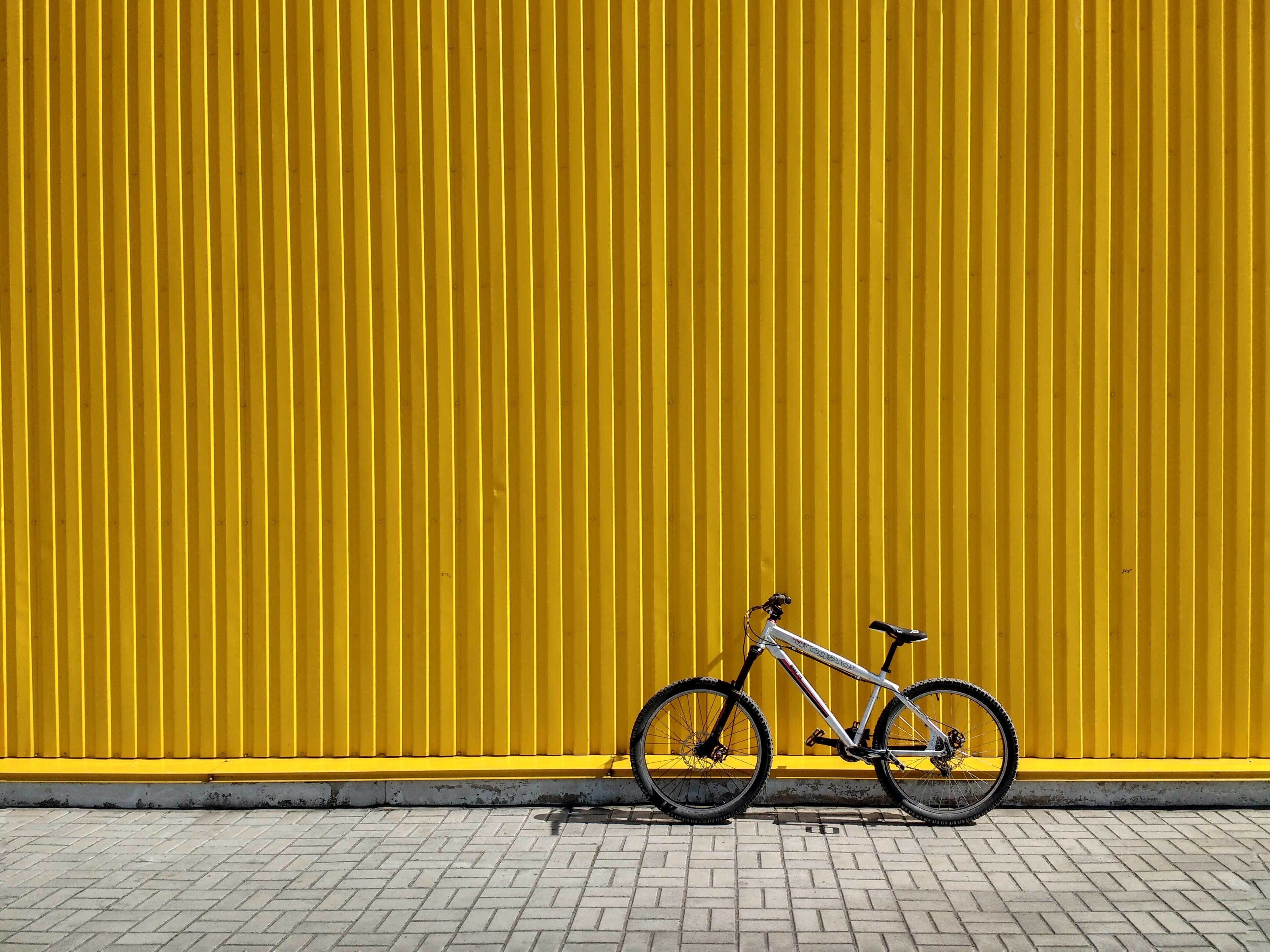 building, wall - building feature, yellow, wall, no people, footpath, sunlight, day, land vehicle, mode of transportation, corrugated, metal, gray, street, HD Wallpaper
