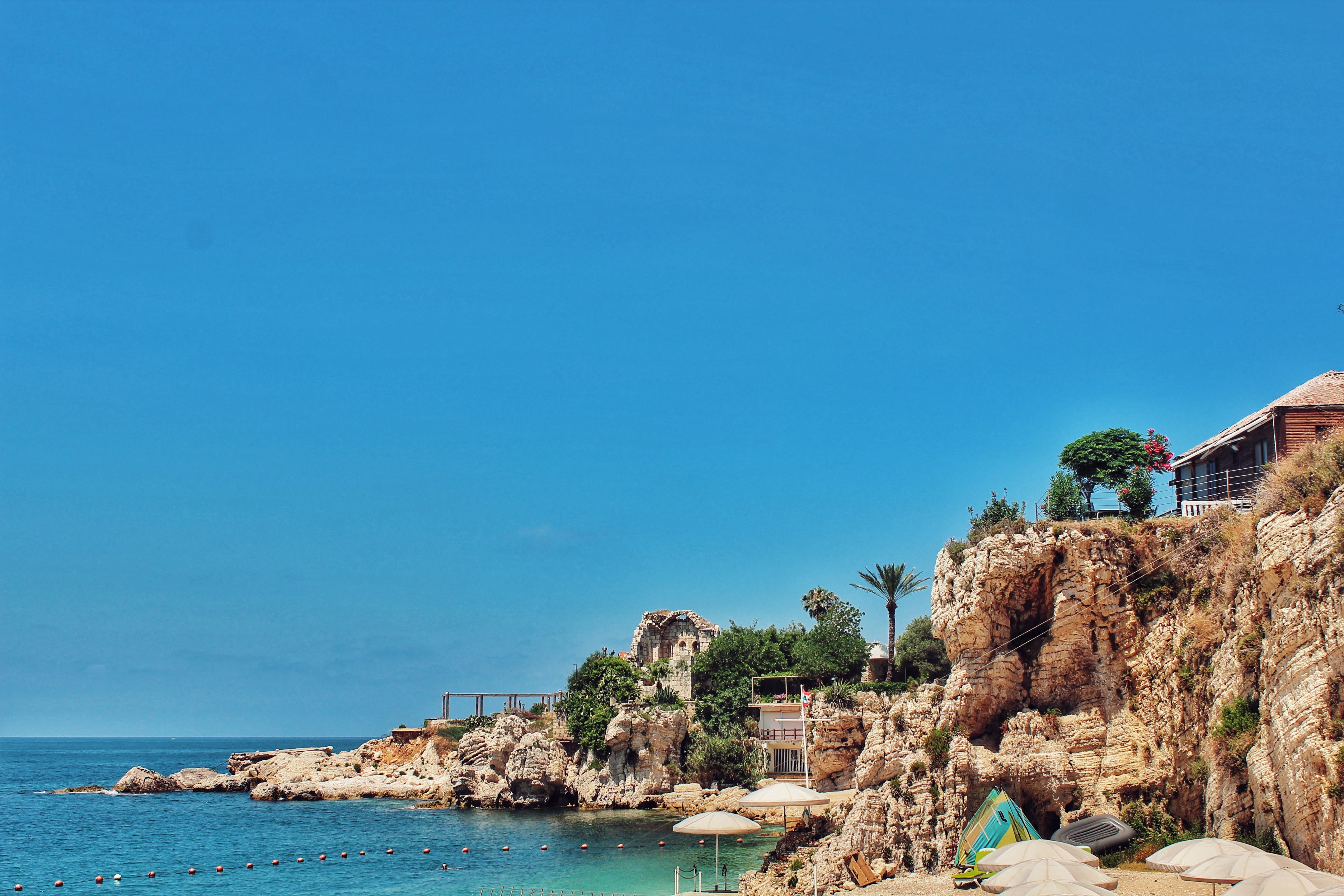 tabarja beach, water, land, blue, day, rock, clear sky, beauty in nature, nature, no people, scenics - nature, outdoors, copy space, built structure, building exterior, HD Wallpaper
