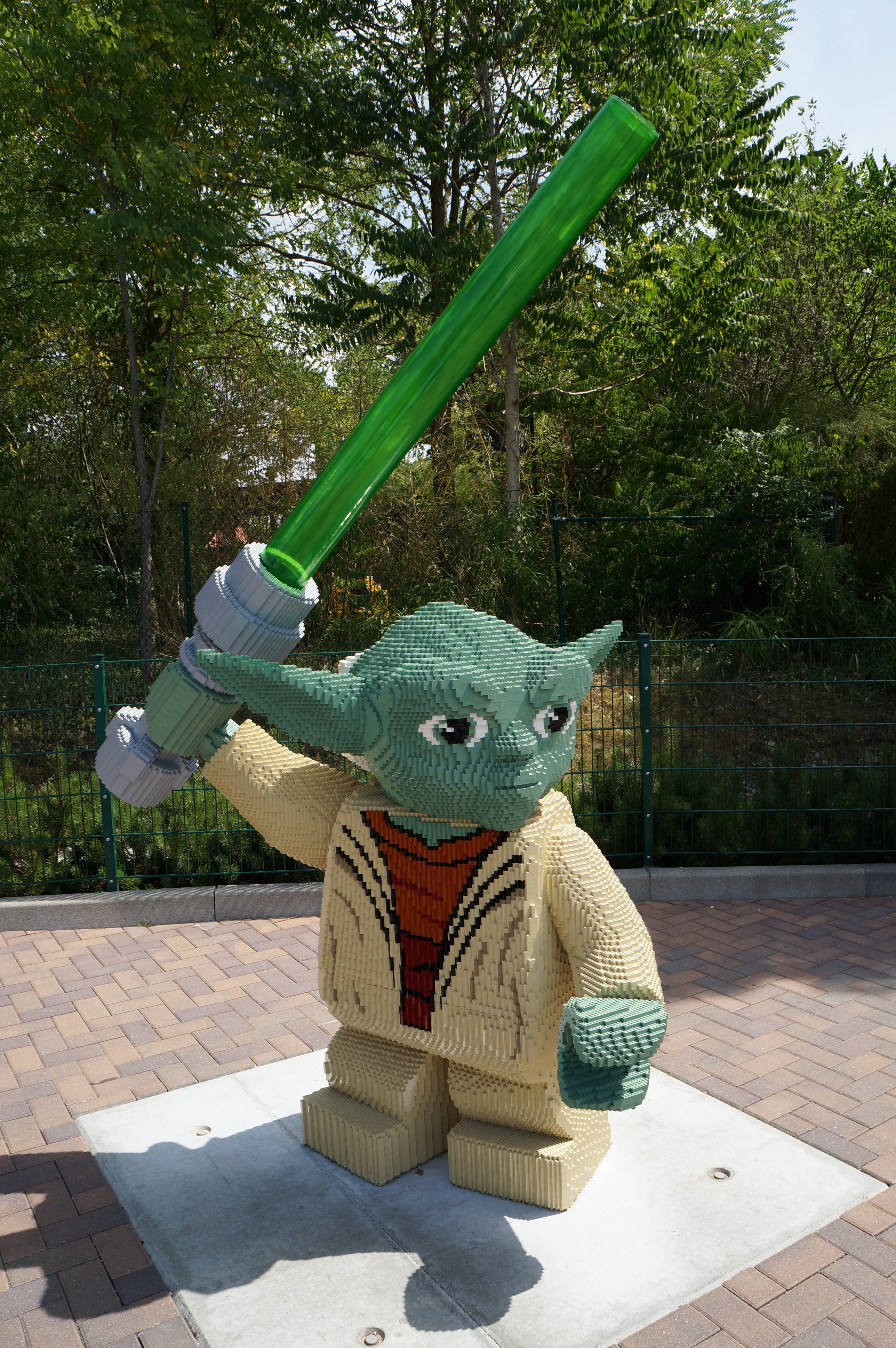 Jedi, laser sword, no people, from lego, day, green color, outdoors, sunlight, Yoda, plant, outdoor play equipment, shadow, 4K, statue, Star Wars, Lego, Phone HD Wallpaper
