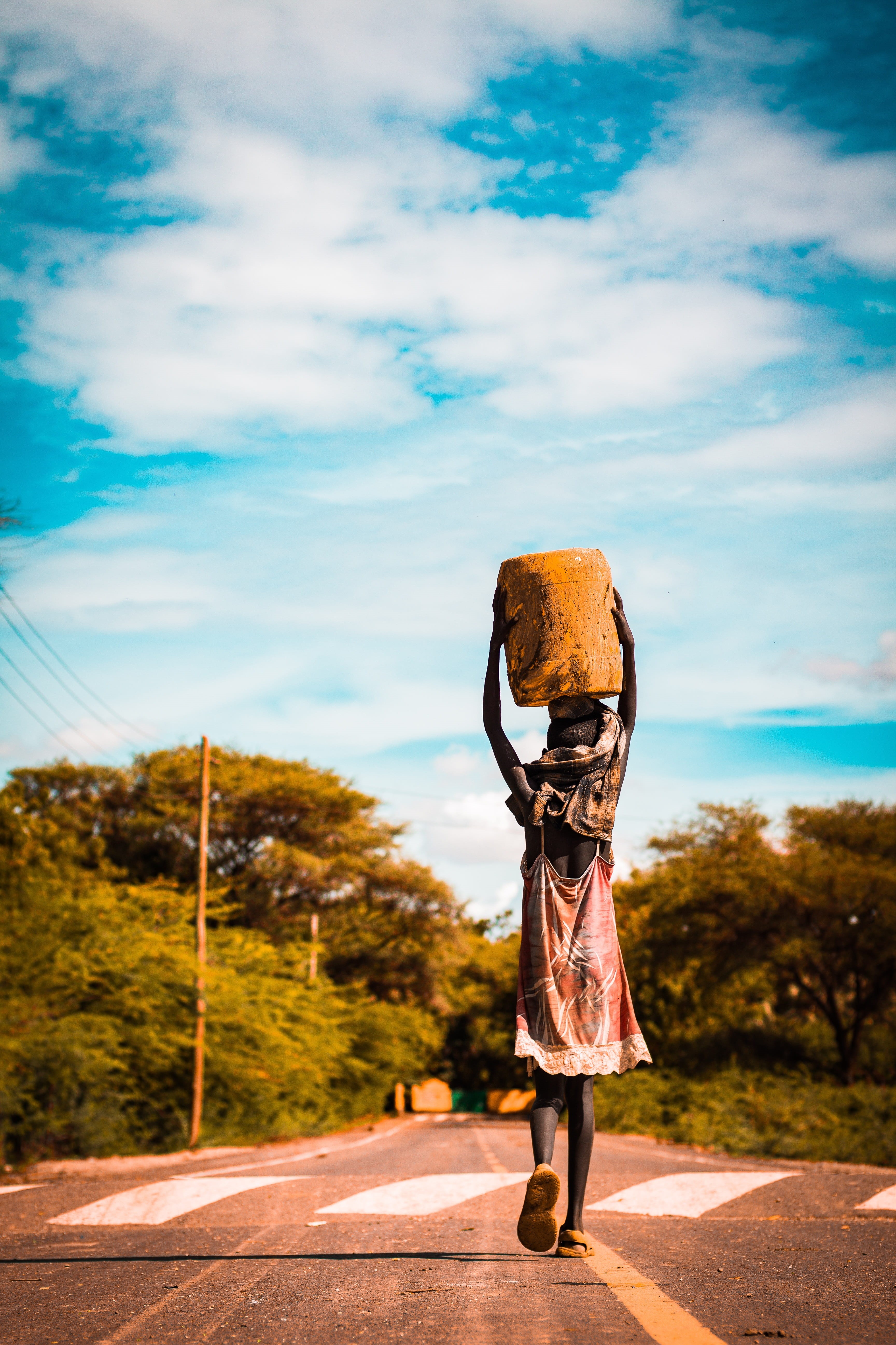 nature, real people, sky, trees, adult, water, basket, road, focus, leisure activity, orange, standing, casual clothing, forest, africa, jerrycan, women, Phone HD Wallpaper