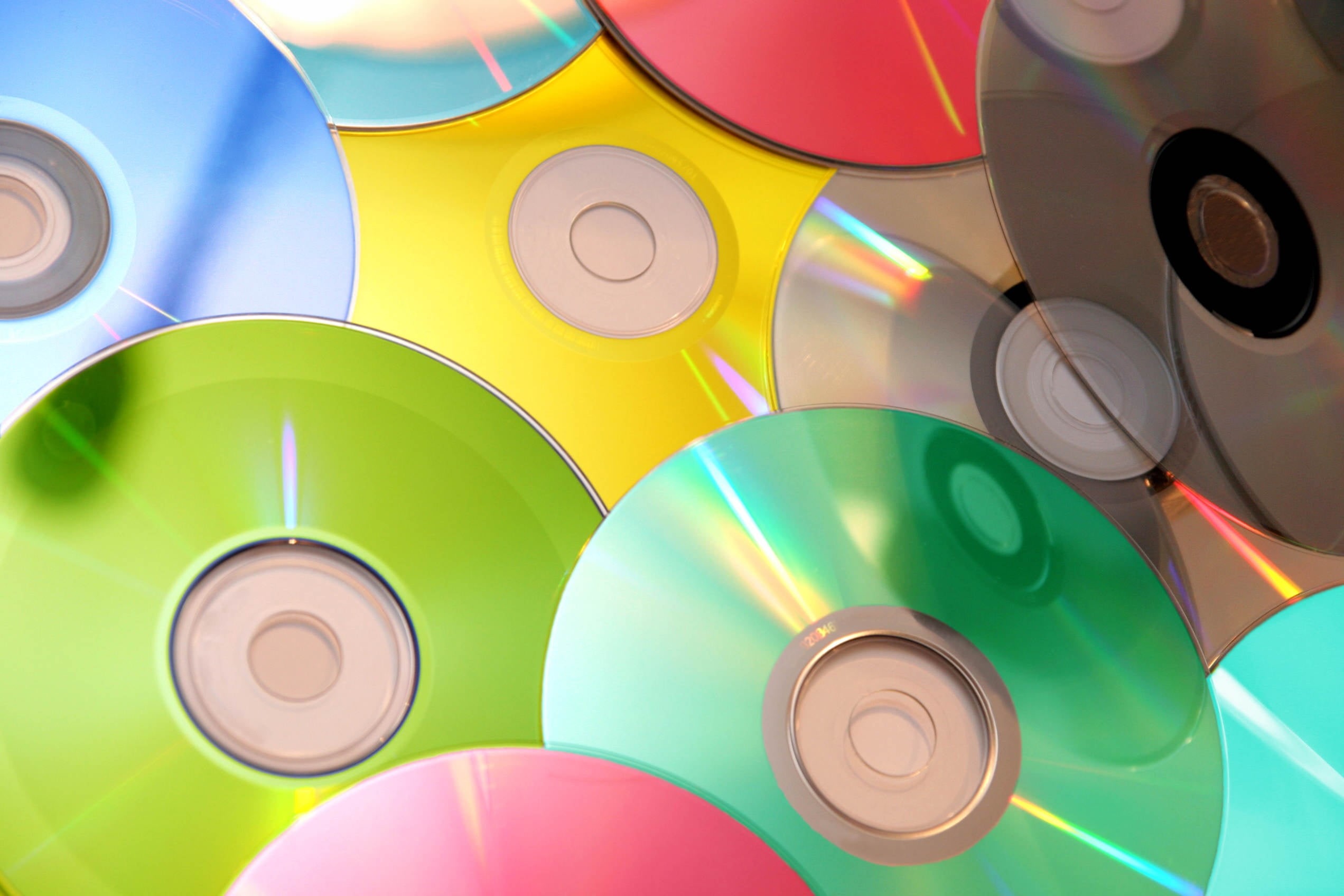 arts culture and entertainment, multi Colored, plastic, yellow, computer, colors, equipment, still life, discs, dVD, indoors, red, studio shot, data, 1080P, HD Wallpaper