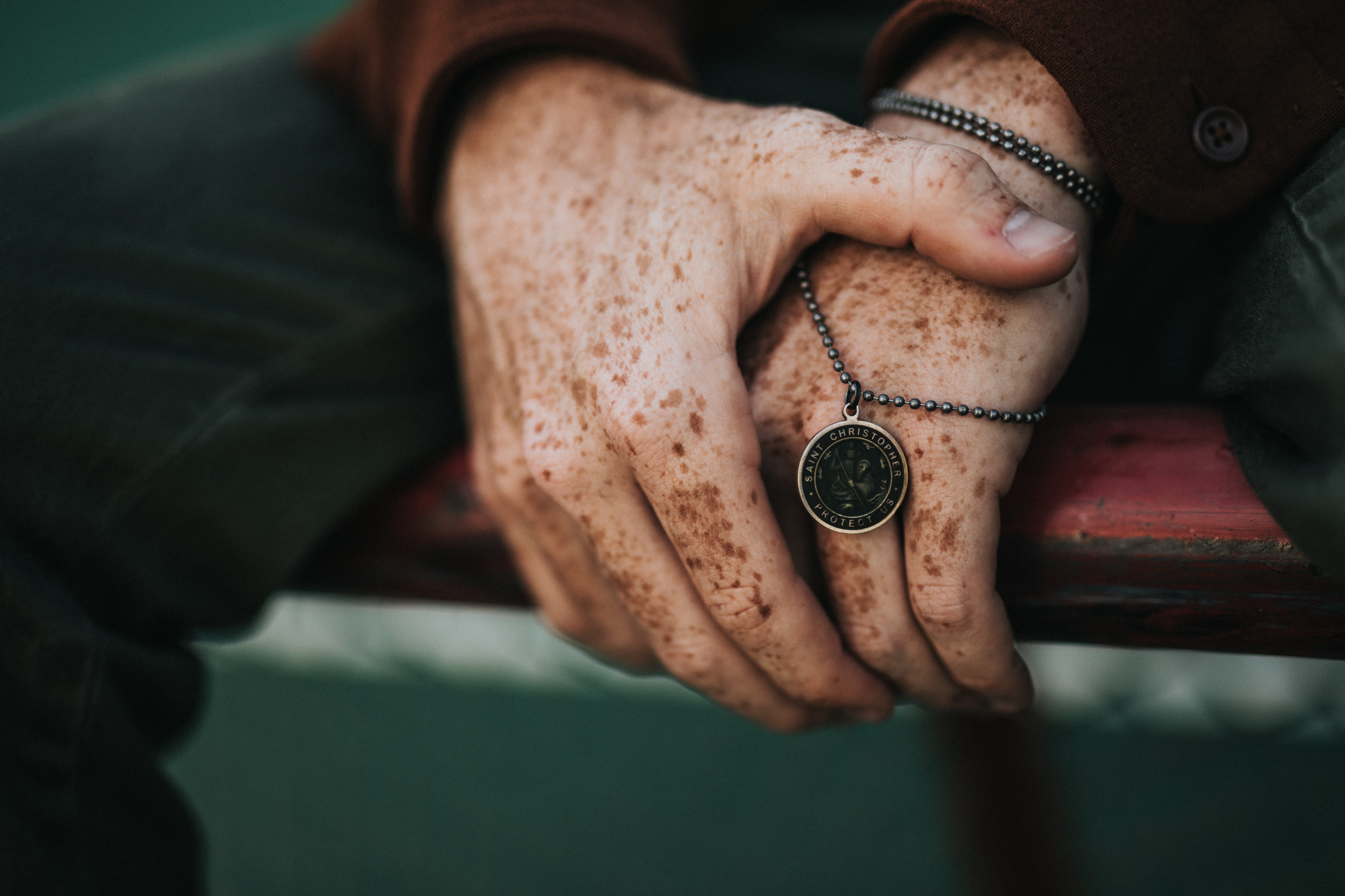 adult, freckle, holding, human hand, indoors, blur, bokeh, gold, time, jewelery, jewelry, necklace, emotion, round, model, focus on foreground, hand model, HD Wallpaper