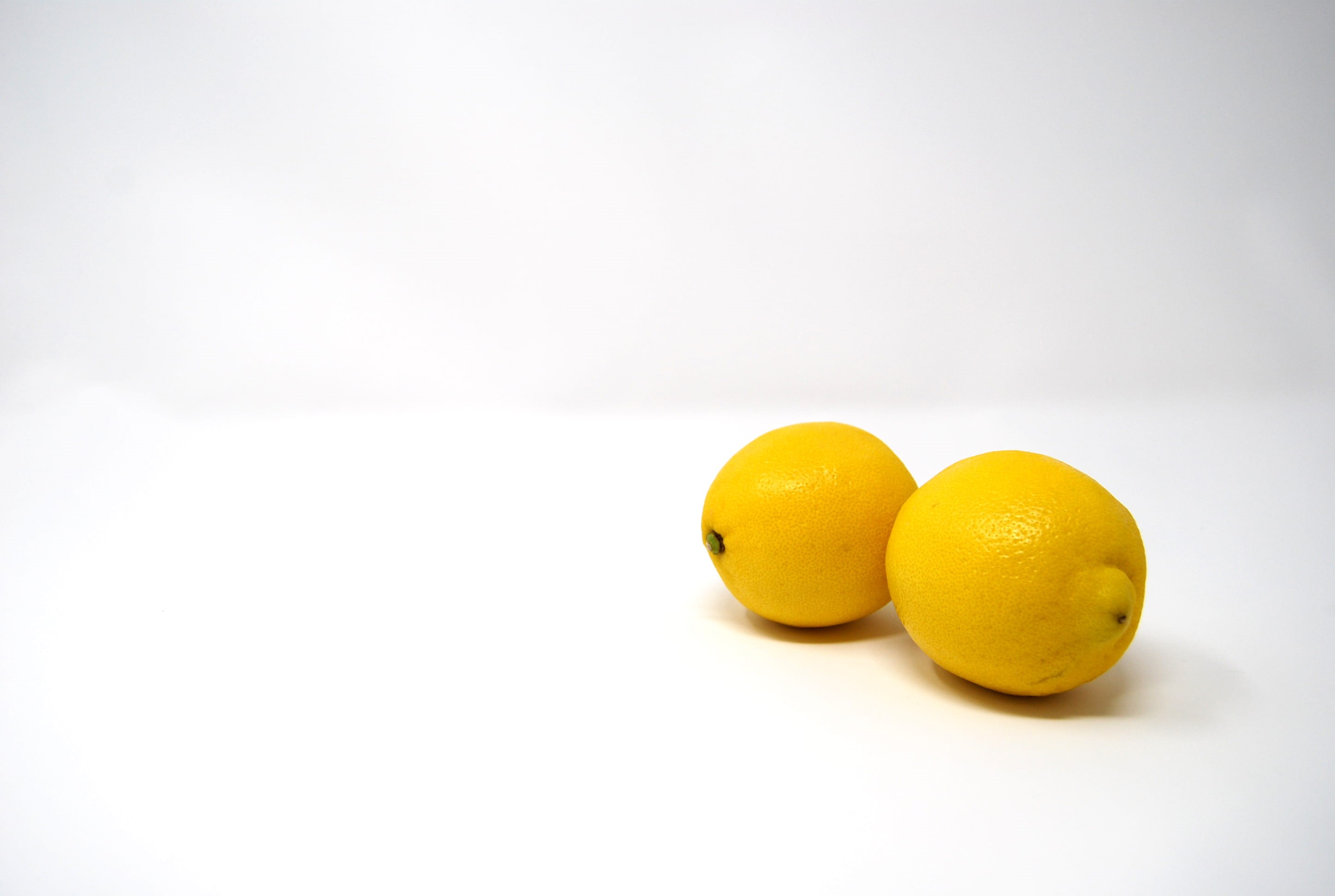 close-up, white, bright, 2K, food, fruit, lemons, citrus fruit, still life, two, two objects, sour taste, cut out, minimalist, healthy eating, indoors, HD Wallpaper