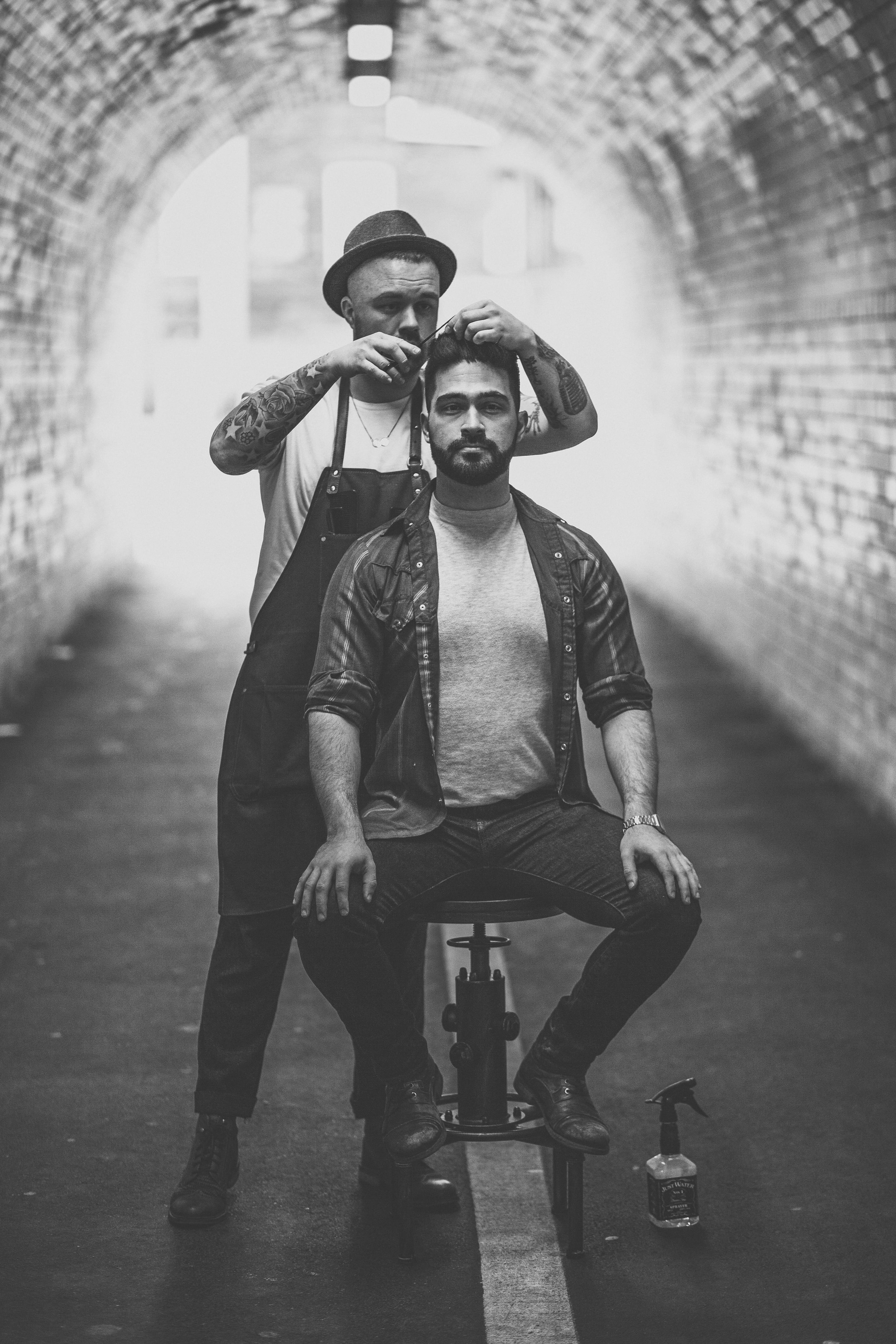 sitting, stay and wander, leisure activity, hairdresser, hat, young men, person, casual clothing, barber, built structure, faded, male, hair cut, grayscale, Phone HD Wallpaper