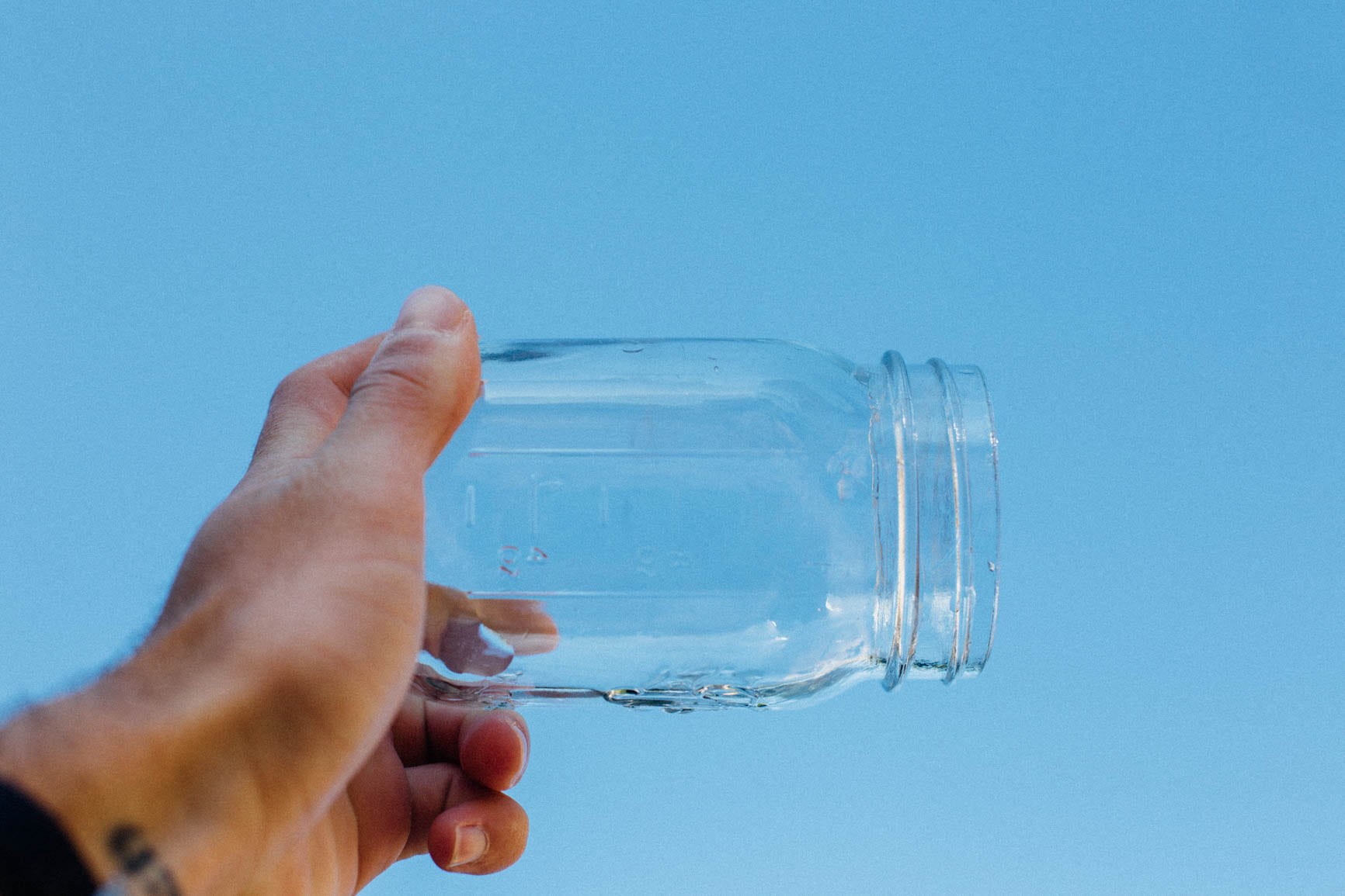 jar, 720P, one person, hand, wall, day, blue background, water, close-up, people, clear, body part, unrecognizable person, finger, studio shot, holding, HD Wallpaper