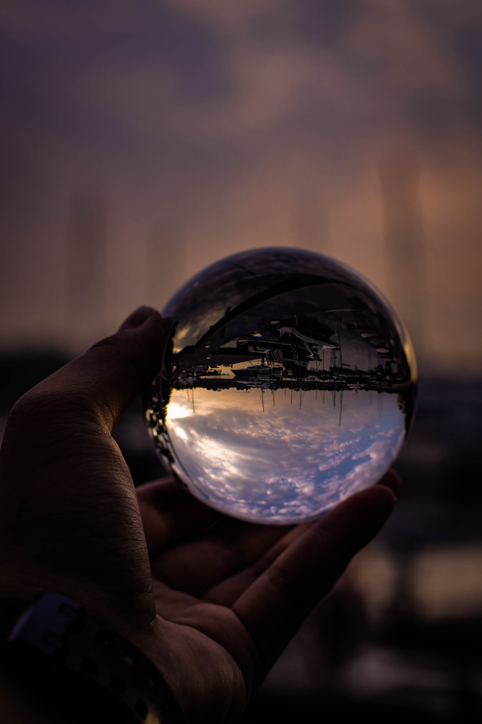 crystal clear, crystal glass, real people, reflection, sky, sunset, human body part, Lensball, crystal ball, sphere, finger, close-up, ball, one person, Phone HD Wallpaper