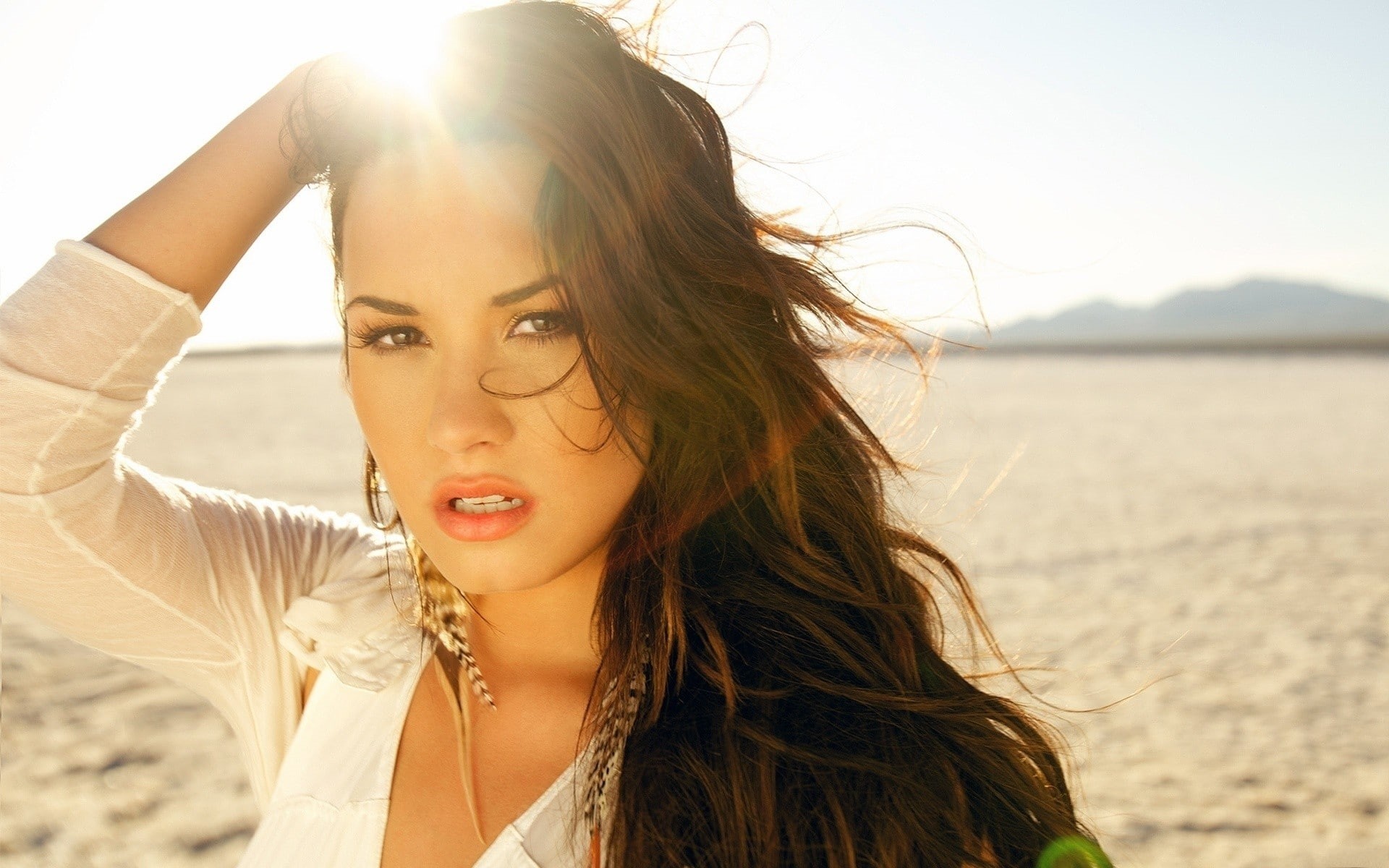 hands in hair, lens flare, looking at viewer, backlighting, brunette, singer, long hair, Demi Lovato, women, women outdoors, 1080P, long eyelashes, HD Wallpaper