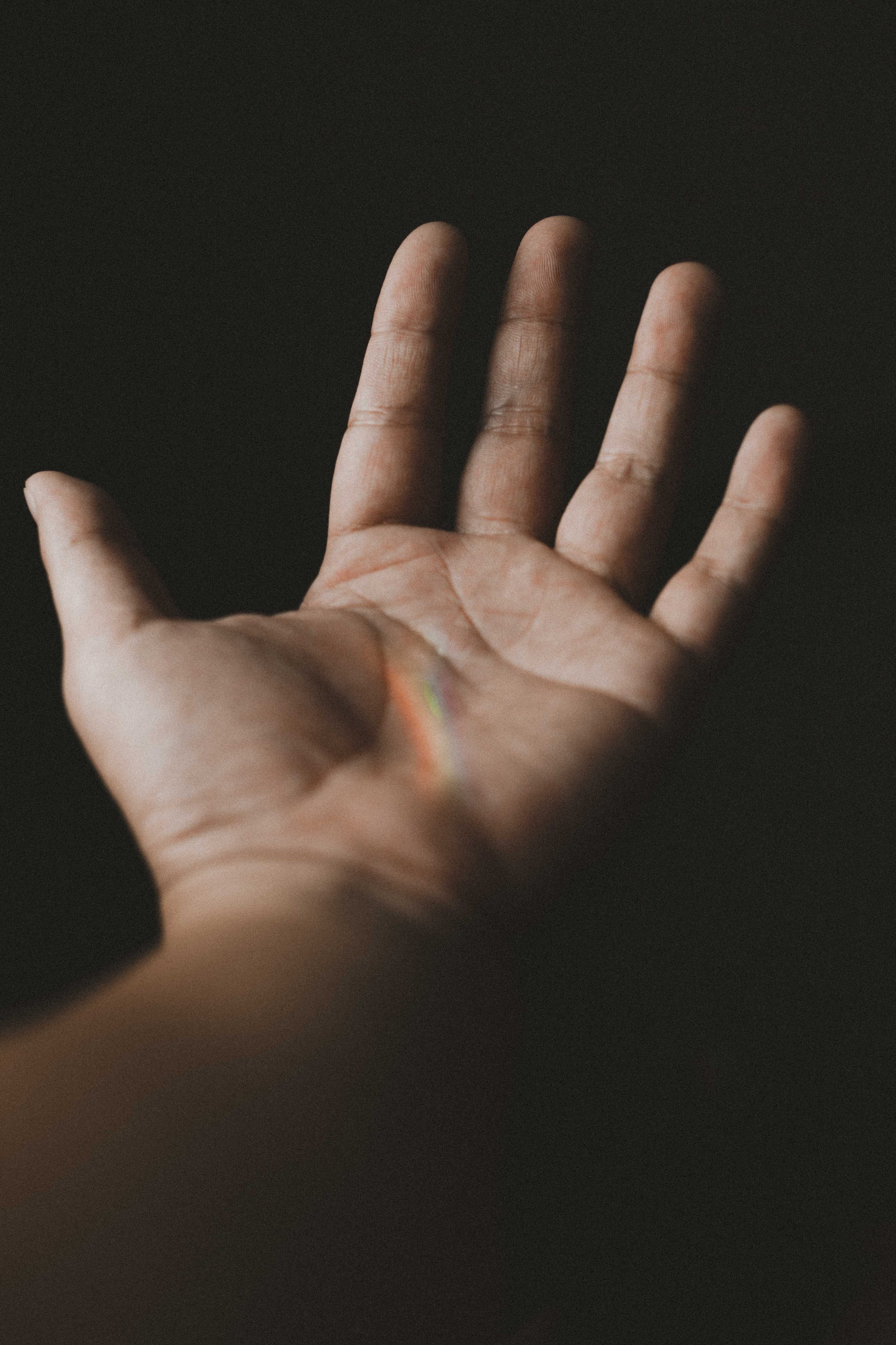 hand, unrecognizable person, strech, story, body part, human body part, lifestyles, hope, indoors, skin, close-up, human skin, personal perspective, dark background, Phone HD Wallpaper
