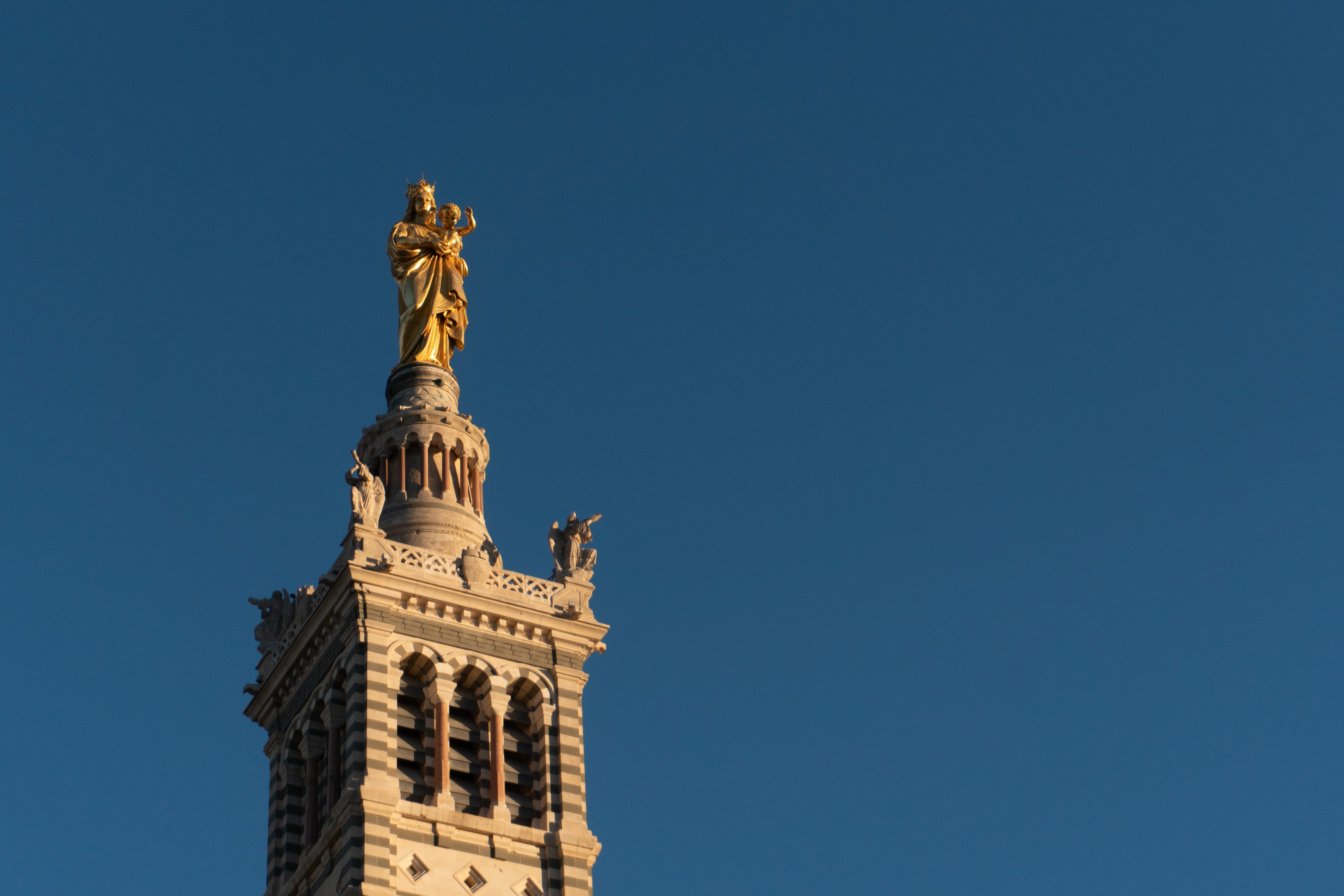 skyscraper, building exterior, clear sky, spire, tower, france, eye, clock tower, brown, sculpture, art and craft, architecture, statue, marseille, built structure, HD Wallpaper