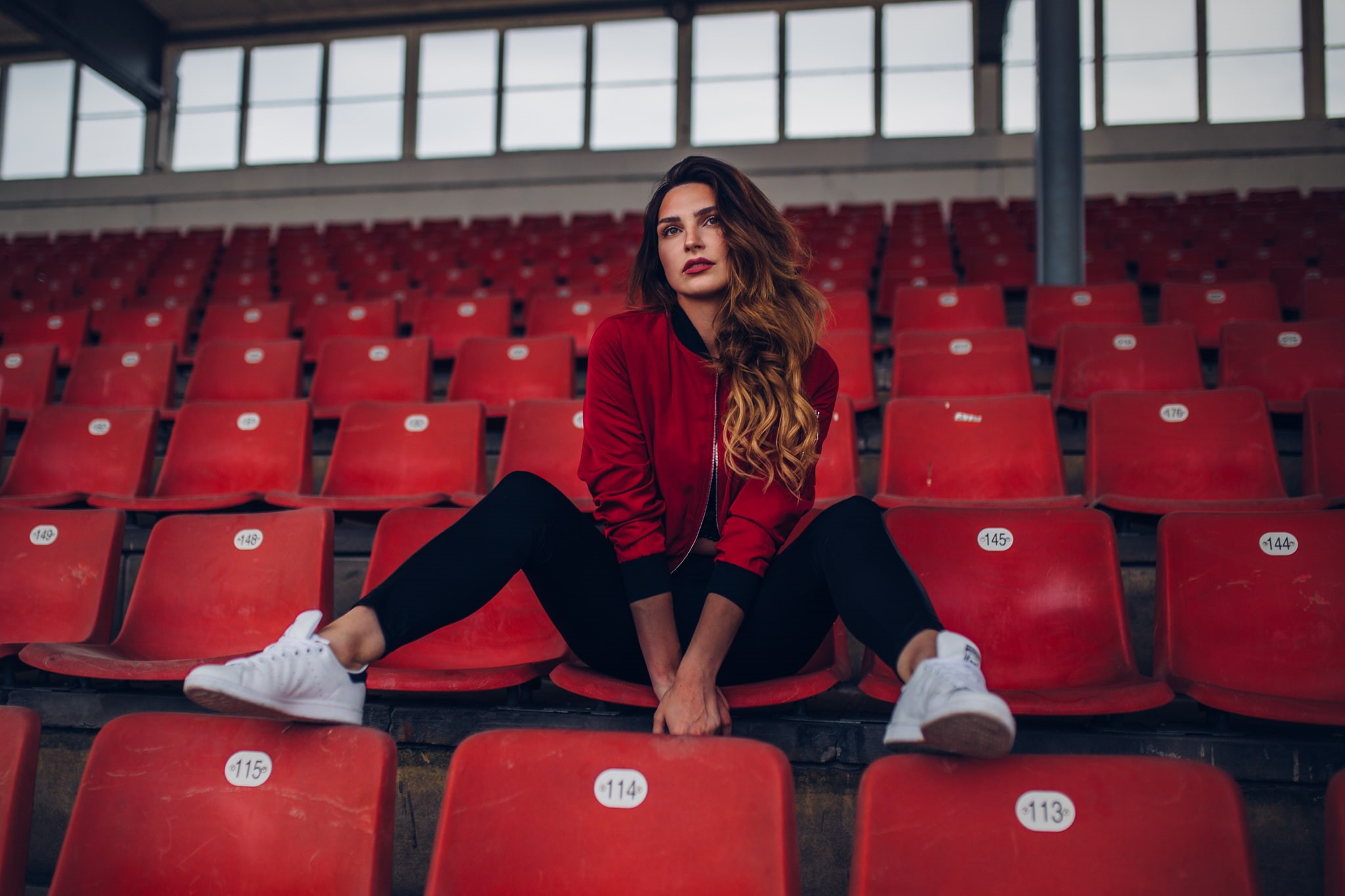Alla Lemax, women, 1080P, sneakers, stadium, red jackets, sitting, brunette, jacket, HD Wallpaper