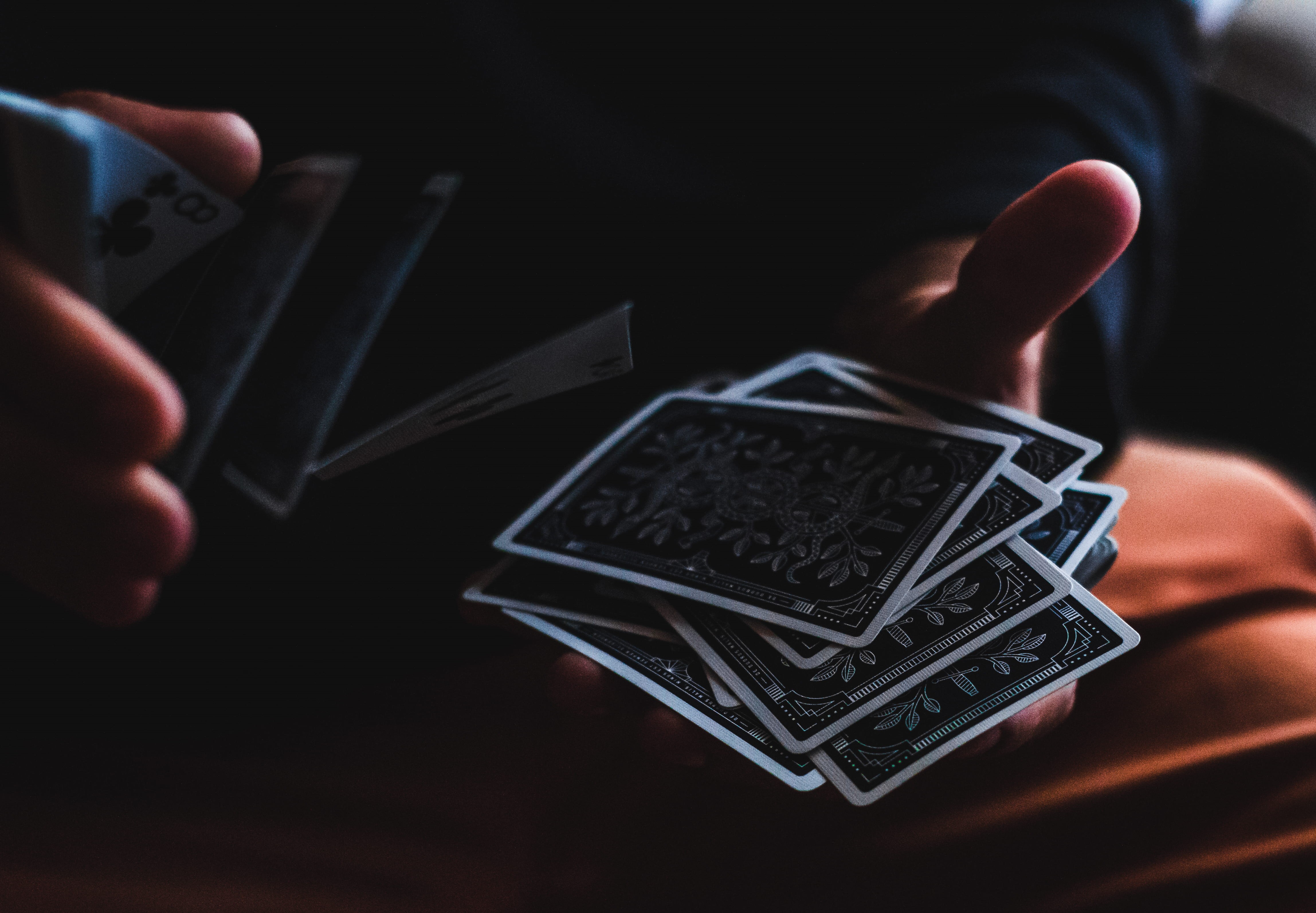 black background, 4K, communication, shuffling, dark, cards, holding, close-up, hand, technology, one person, adult, playing, finger, human hand, connection, HD Wallpaper