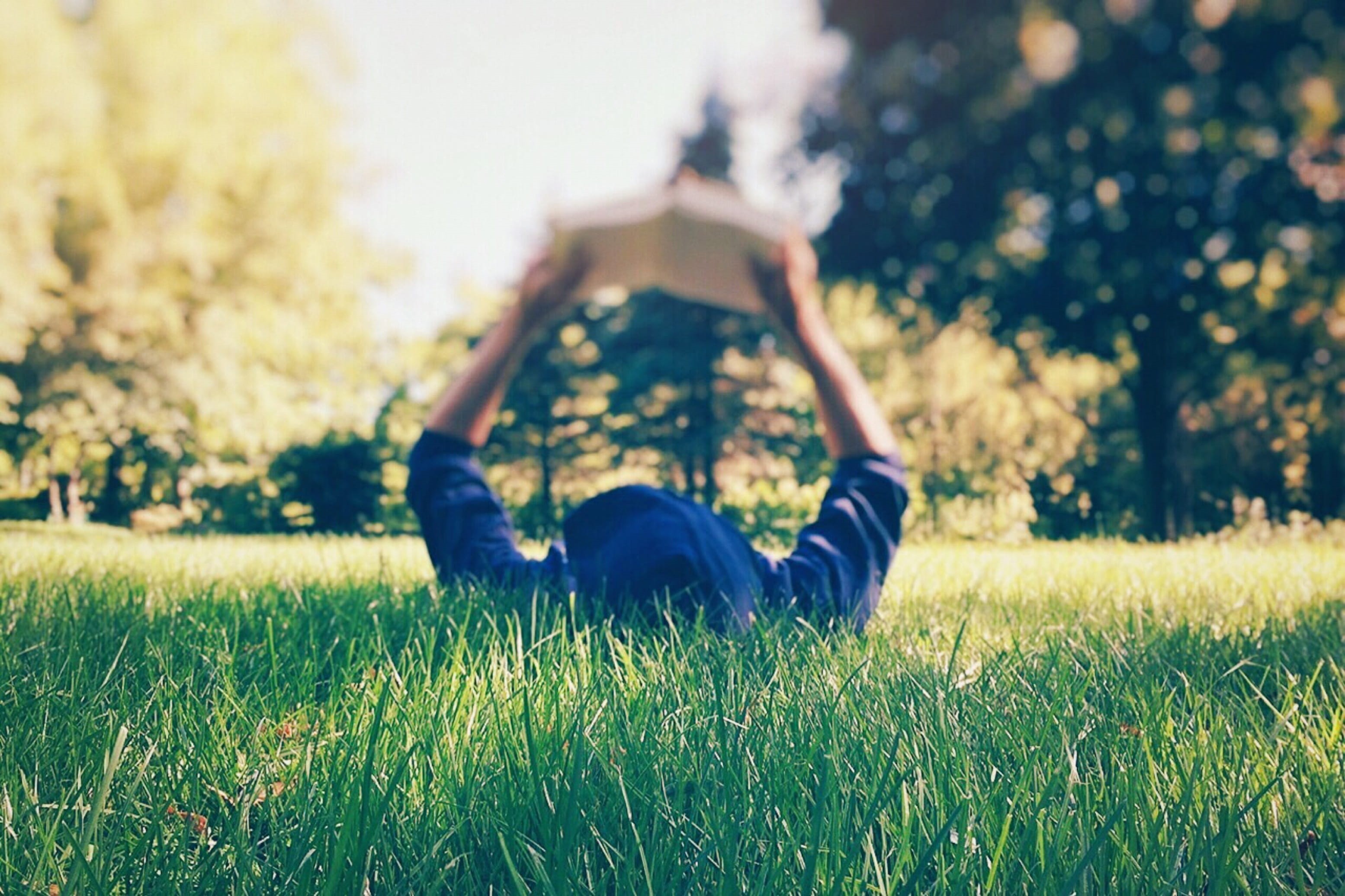 blue, field, daytime, people, reading, nature, arms raised, hoodie, in blue, park - Man Made Space, relaxation, plant, lying on back, meadow, tree, yard, HD Wallpaper