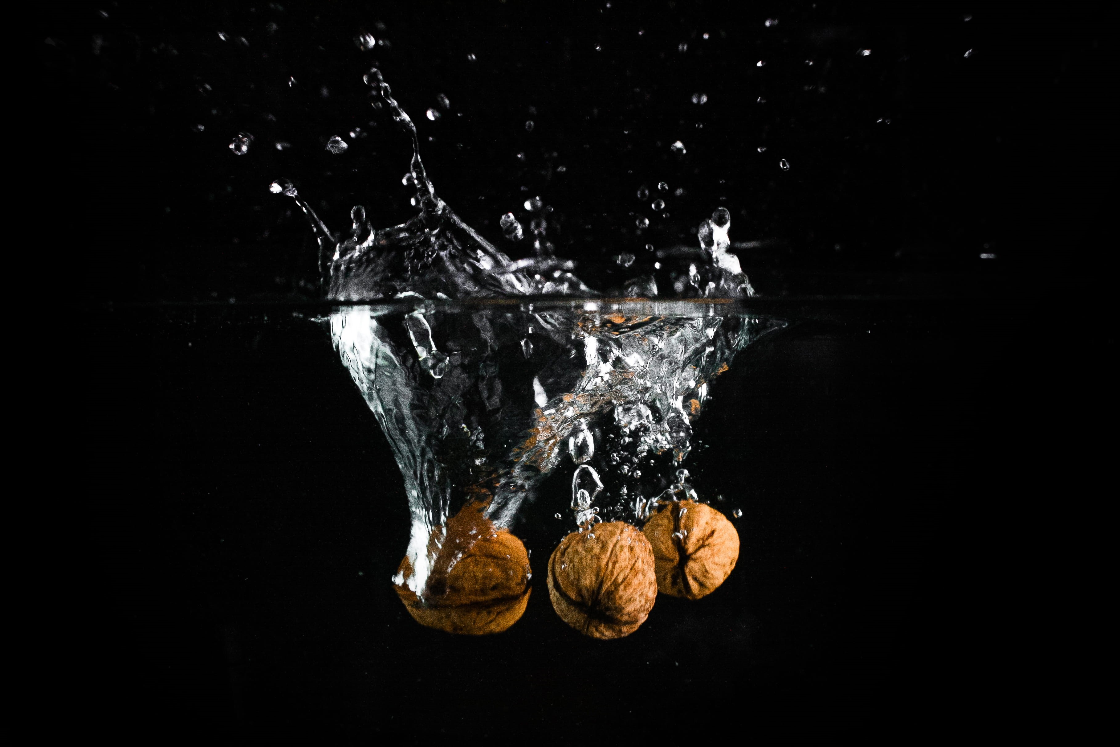 breaking, wet, 2K, falling, motion, black Color, liquid, two objects, bubble, fruit, mid-air, Nuts, no people, nature, indoors, close-up, underwater, studio shot, HD Wallpaper