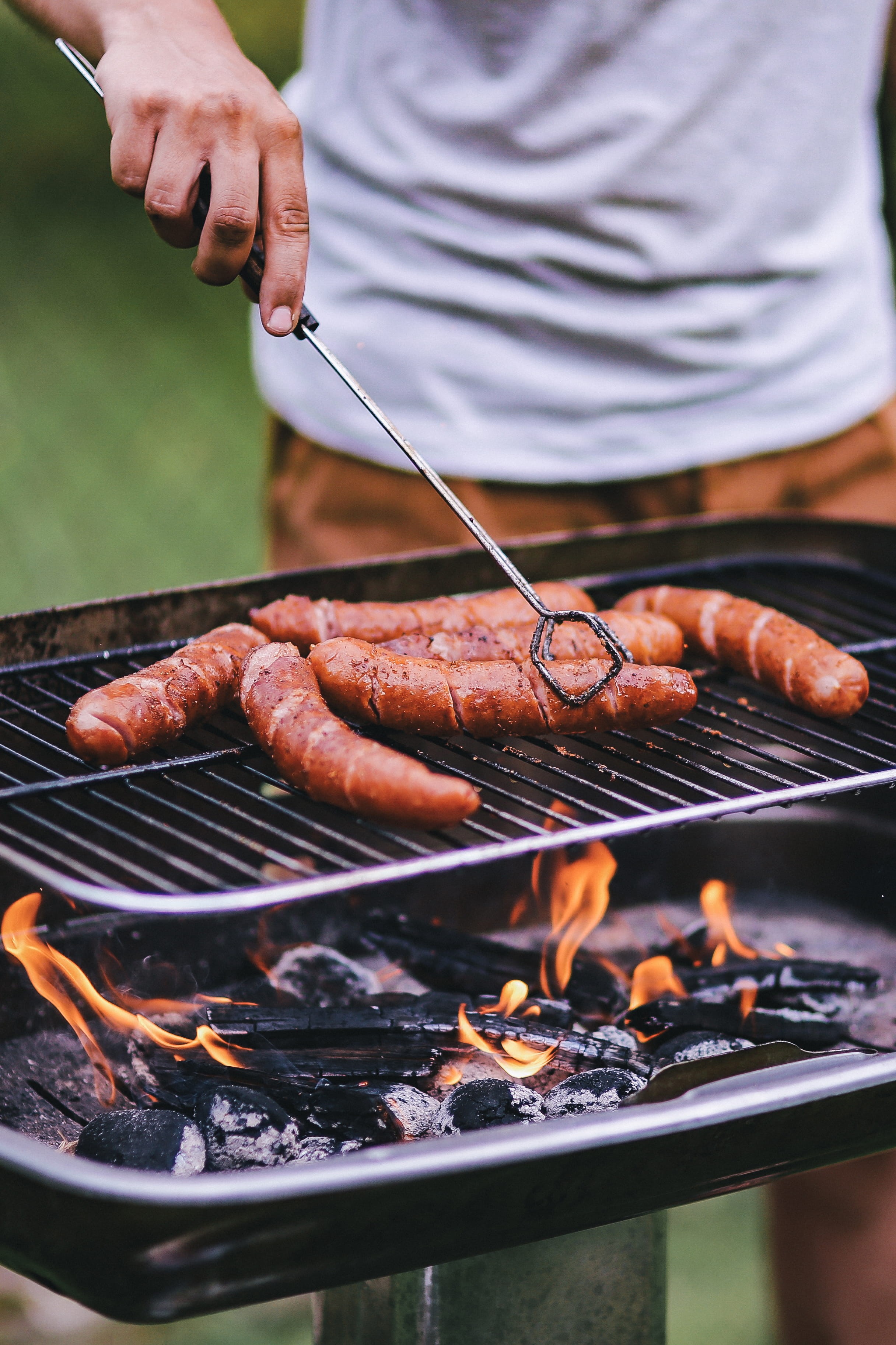 meal, outdoors, serving tongs, holding, coal, human hand, heat - Temperature, close-up, sausages, sausage, preparation, Pork, cooking, dinner, picnic, grilled, Phone HD Wallpaper