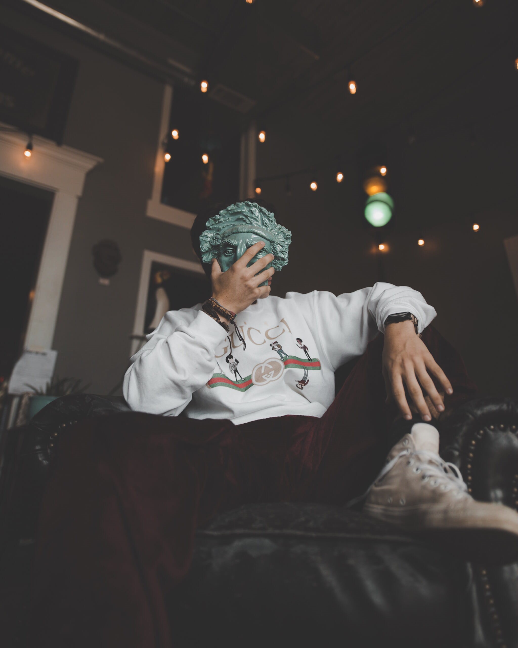 hand, person, statue, leather, holding, senior adult, looking, casual clothing, clothing, three quarter length, lifestyles, women, sitting, sofa, 2K, mask, Phone HD Wallpaper