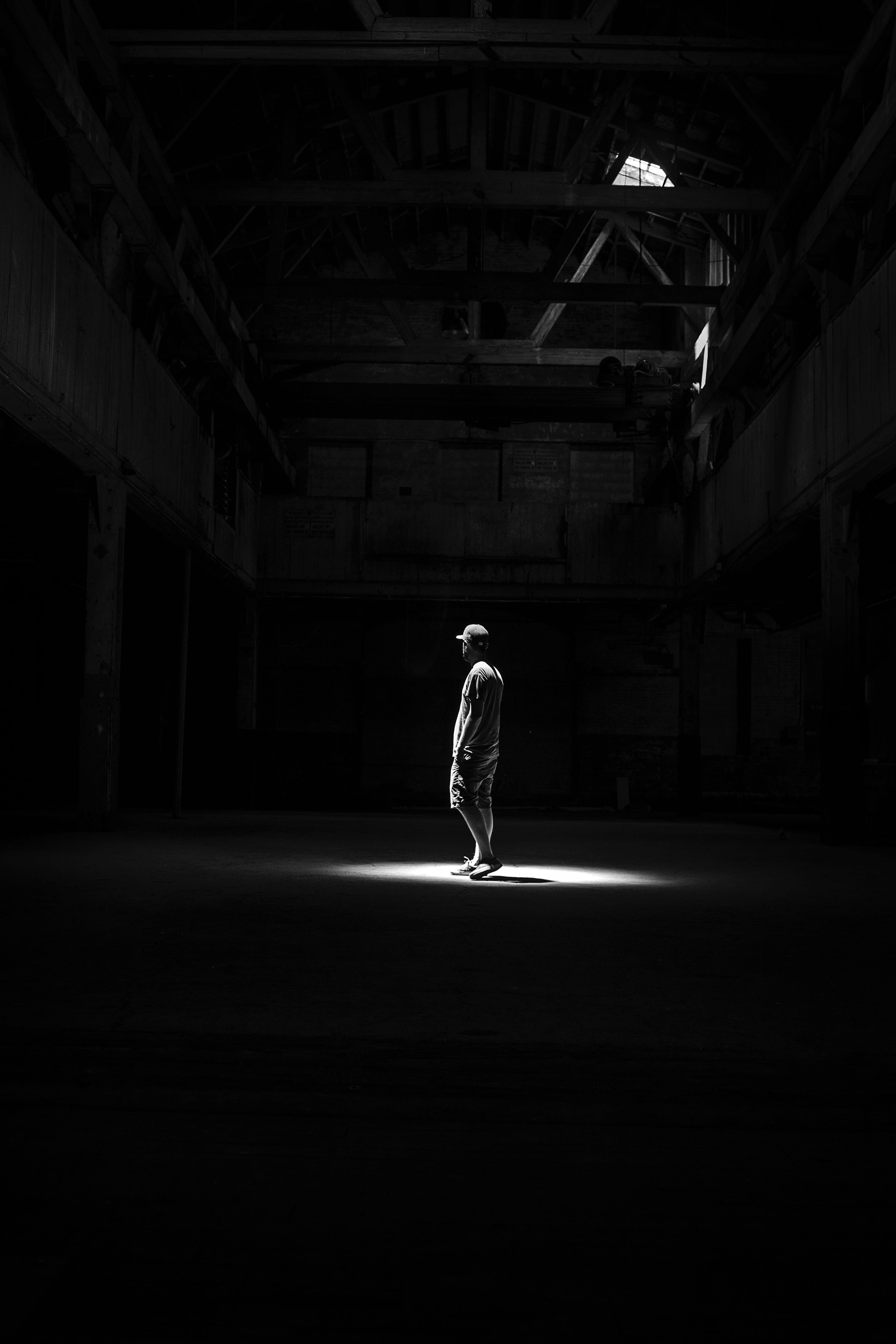 real people, man, shadow, grayscale, illuminated, casual clothing, dim, adult, clothing, ceiling, motion, standing, room, 5K, indoors, photography, one Person, Phone HD Wallpaper