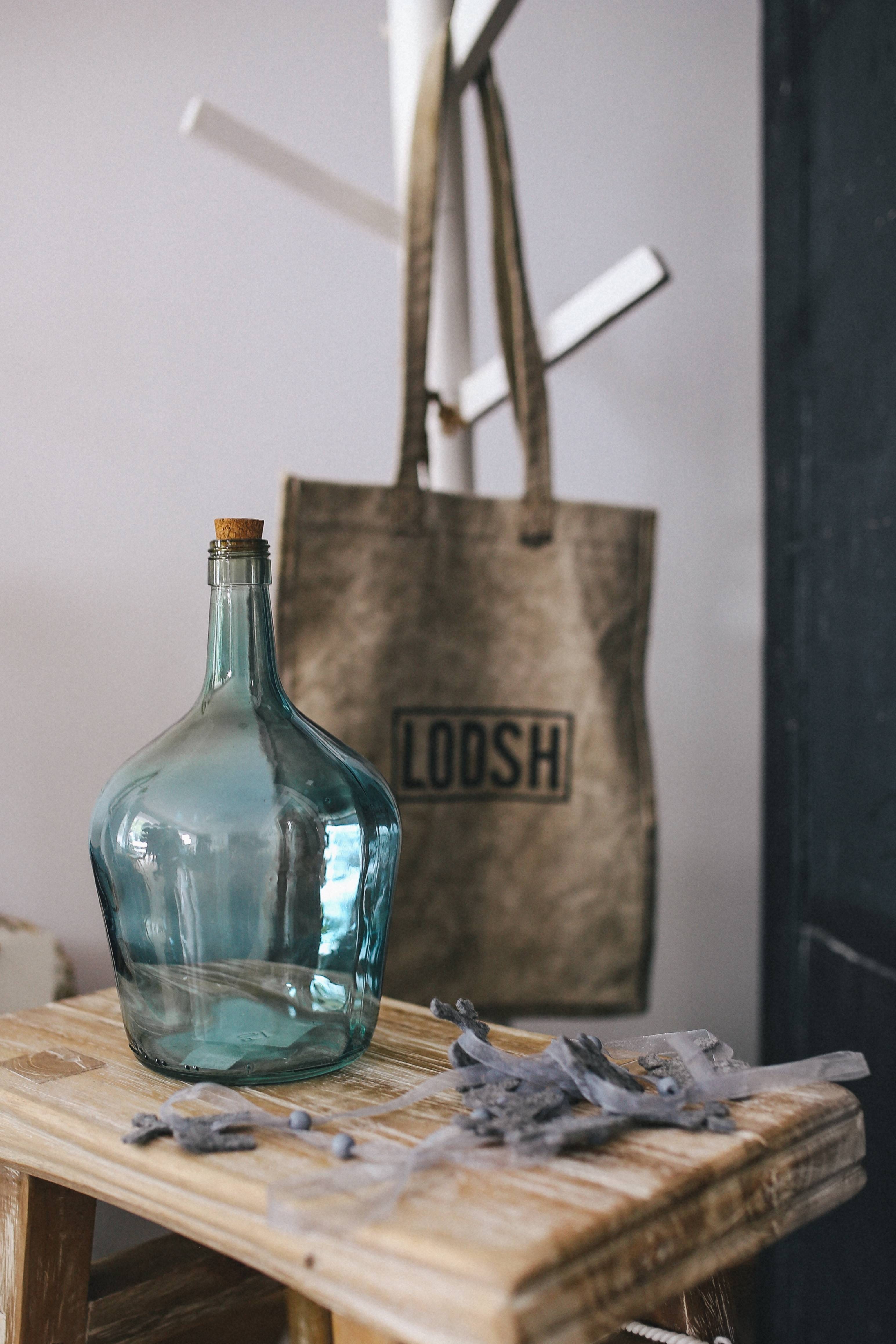 wine bottle, focus on foreground, book, bottles, western script, transparent, seat, still life, text, table, indoors, various, business, container, selective focus, Phone HD Wallpaper