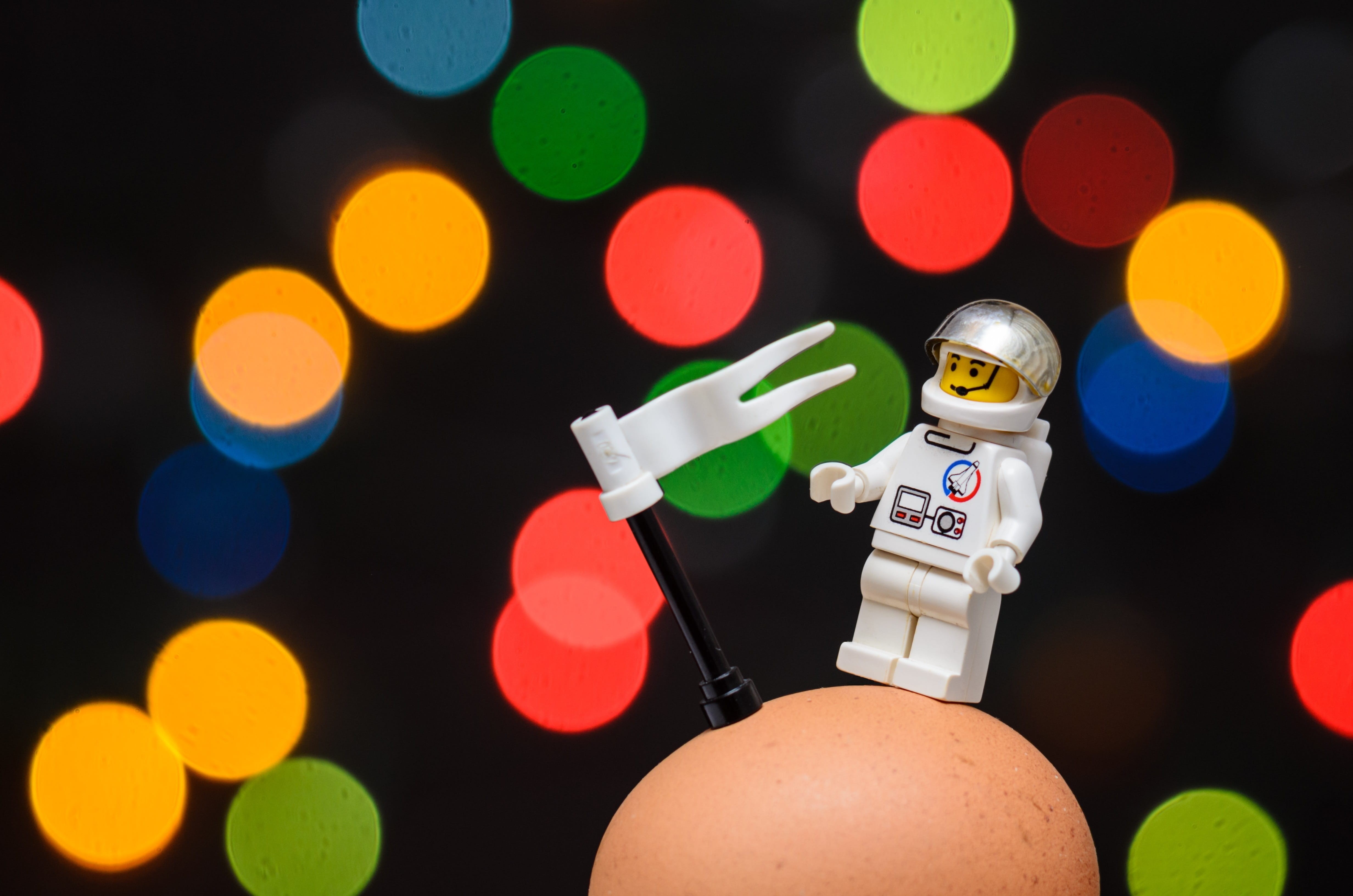 indoors, toys, human body part, astronaut, human limb, close-up, one person, illuminated, fantasy, conquest, space, spaceman, black background, holding, HD Wallpaper