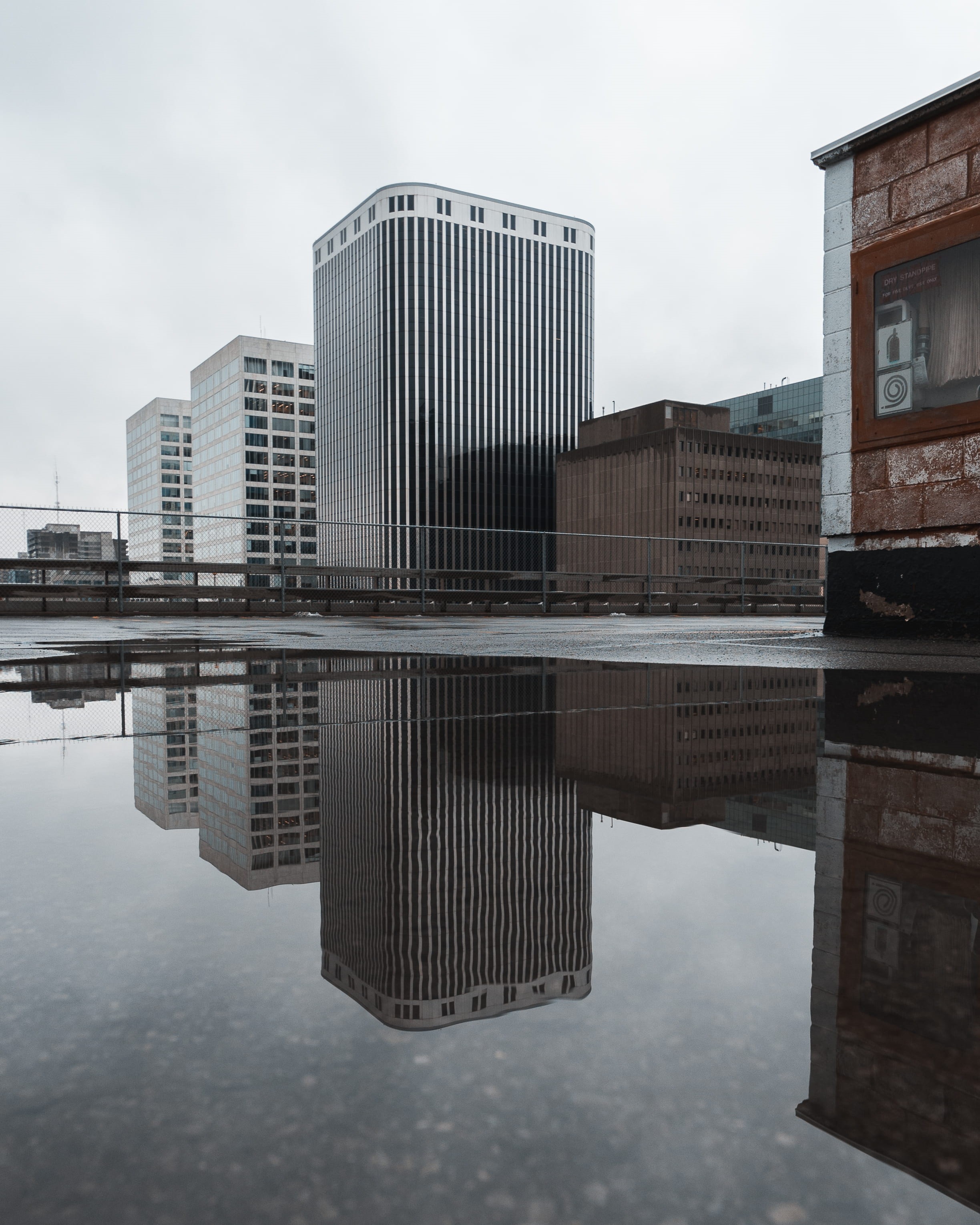 office building exterior, modern, lake, near, buildings, reflecting pool, no people, gray, financial district, nature, waterfront, rise, reflection, 2K, Phone HD Wallpaper