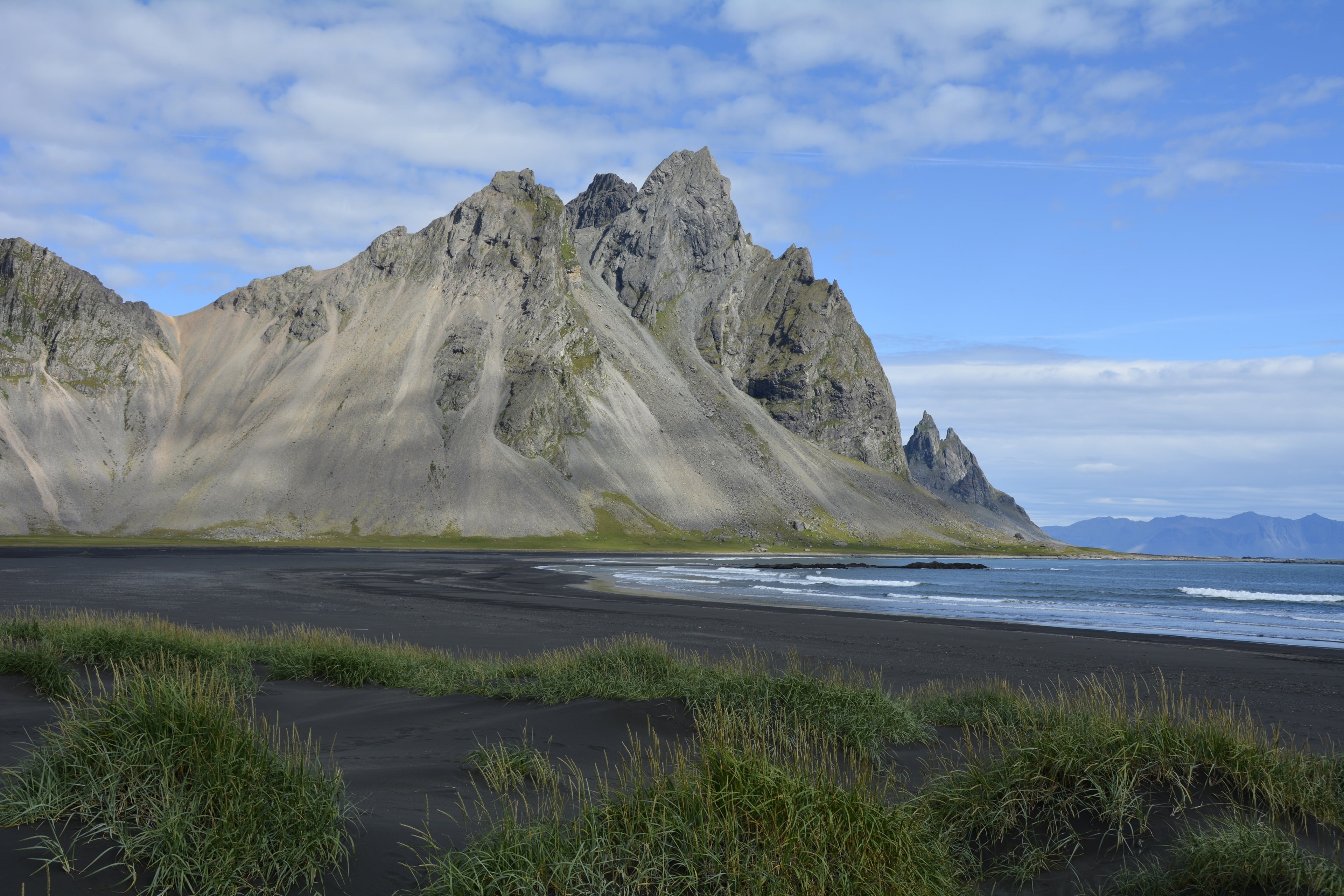 igneous rocks, water, beside, scenics, mountain peak, landscape, body, southeast iceland, nature, vestrahorn mountain, outdoors, mountain range, iceland, HD Wallpaper