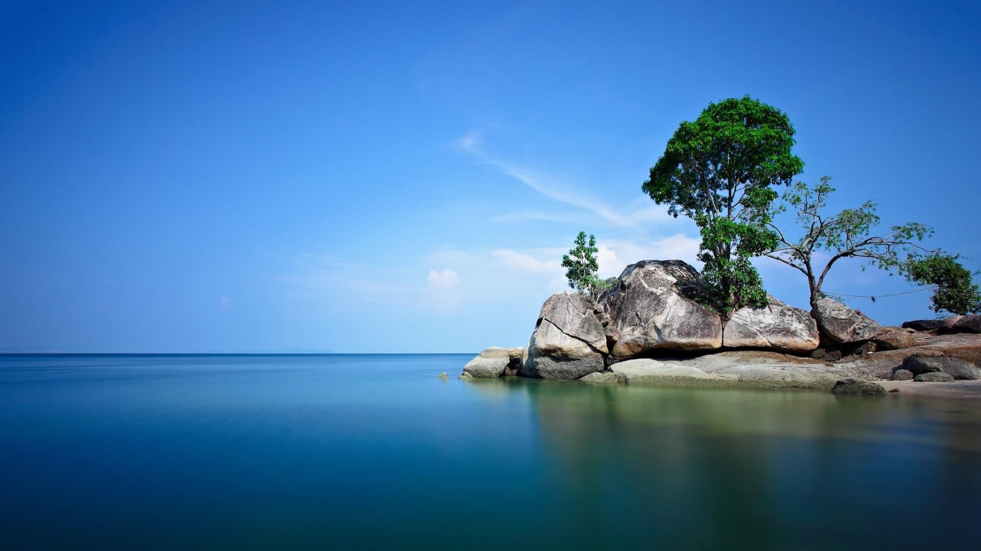 blue water, ocean, calm, blue sky, beauty in nature, rock, blue, sky, sunshine, horizon over water, travel, tranquility, coast, sea, waterscape, 1080P, HD Wallpaper