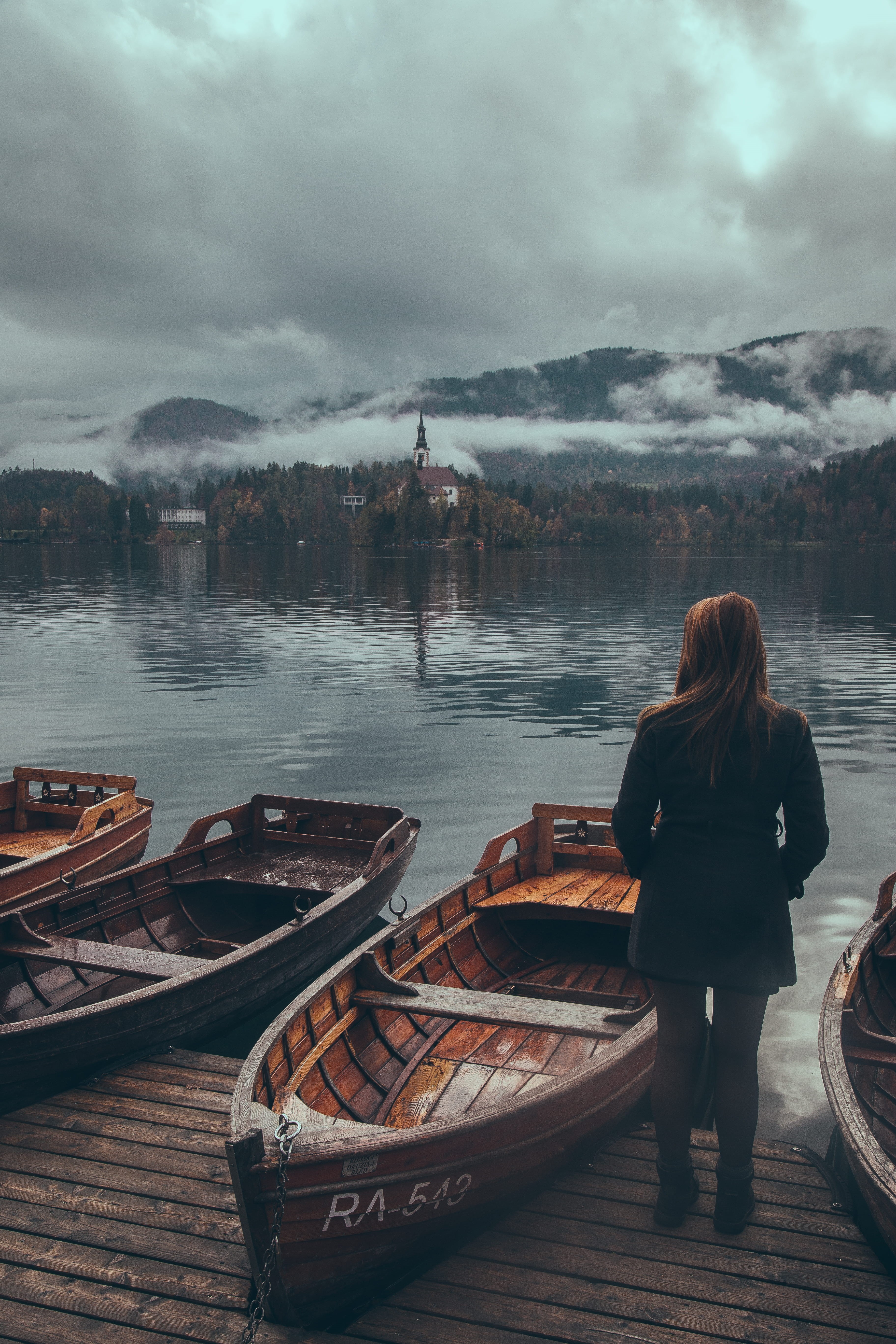 wooden, watercraft, one person, lifestyles, vehicle, vanlife, canoe, nature, clothing, nomadlife, rowboat, moored, slovenia, travel, bled, grey, cloudy, Phone HD Wallpaper
