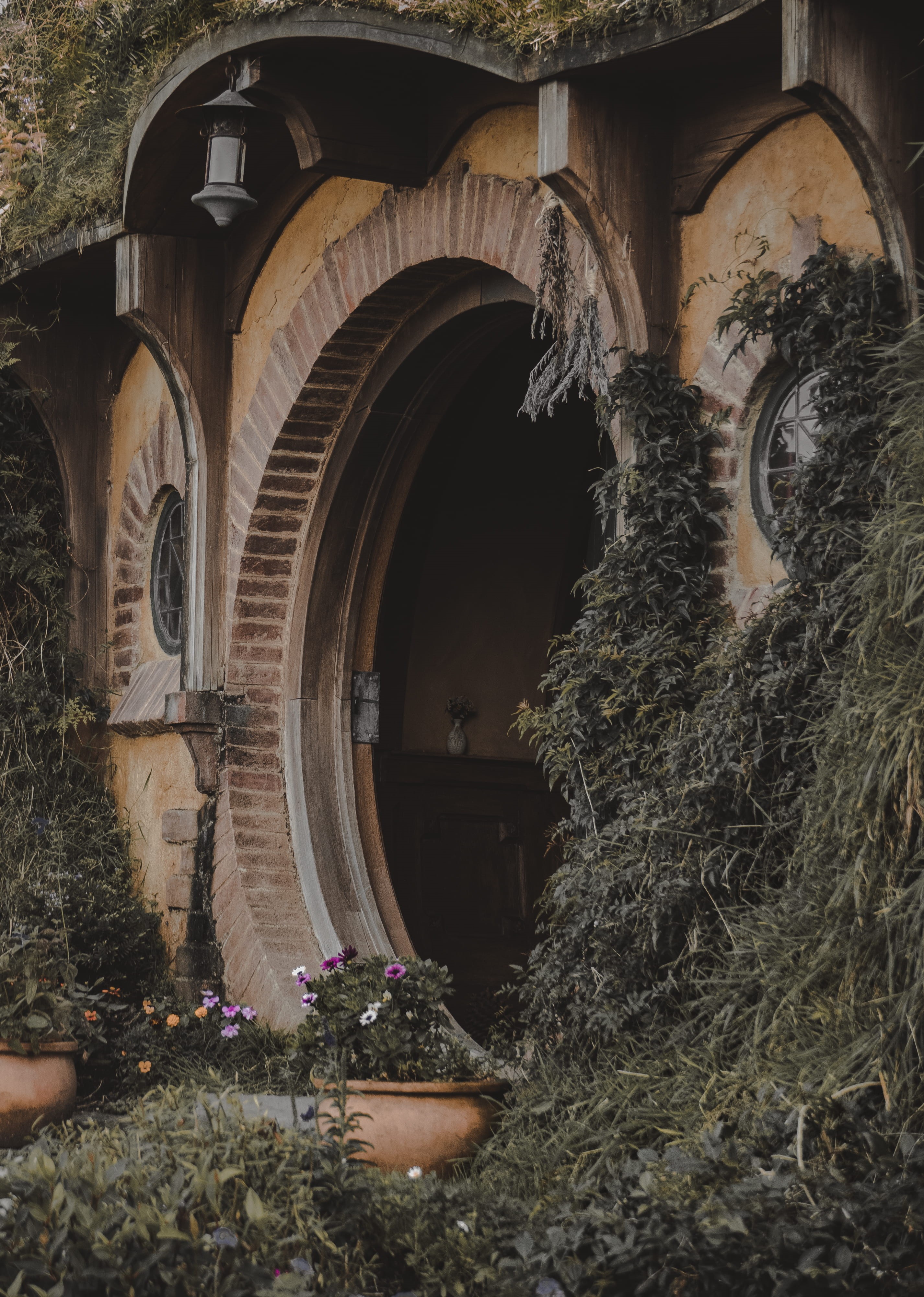 arched, outdoors, hobbit, home, vase, house, production, day, beside, building exterior, creativity, lamp, old, flower, lord of the rings, concrete, pot, Phone HD Wallpaper