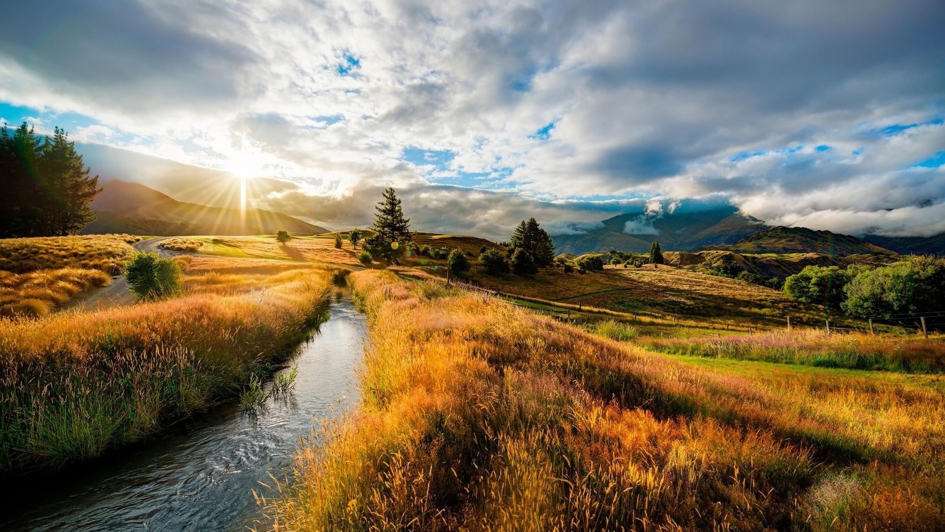 lens flare, tranquility, sun, tranquil scene, no people, water, sunrise, landscape, mountain, beauty in nature, sunlight, cloud, superb, grass, outdoors, HD Wallpaper