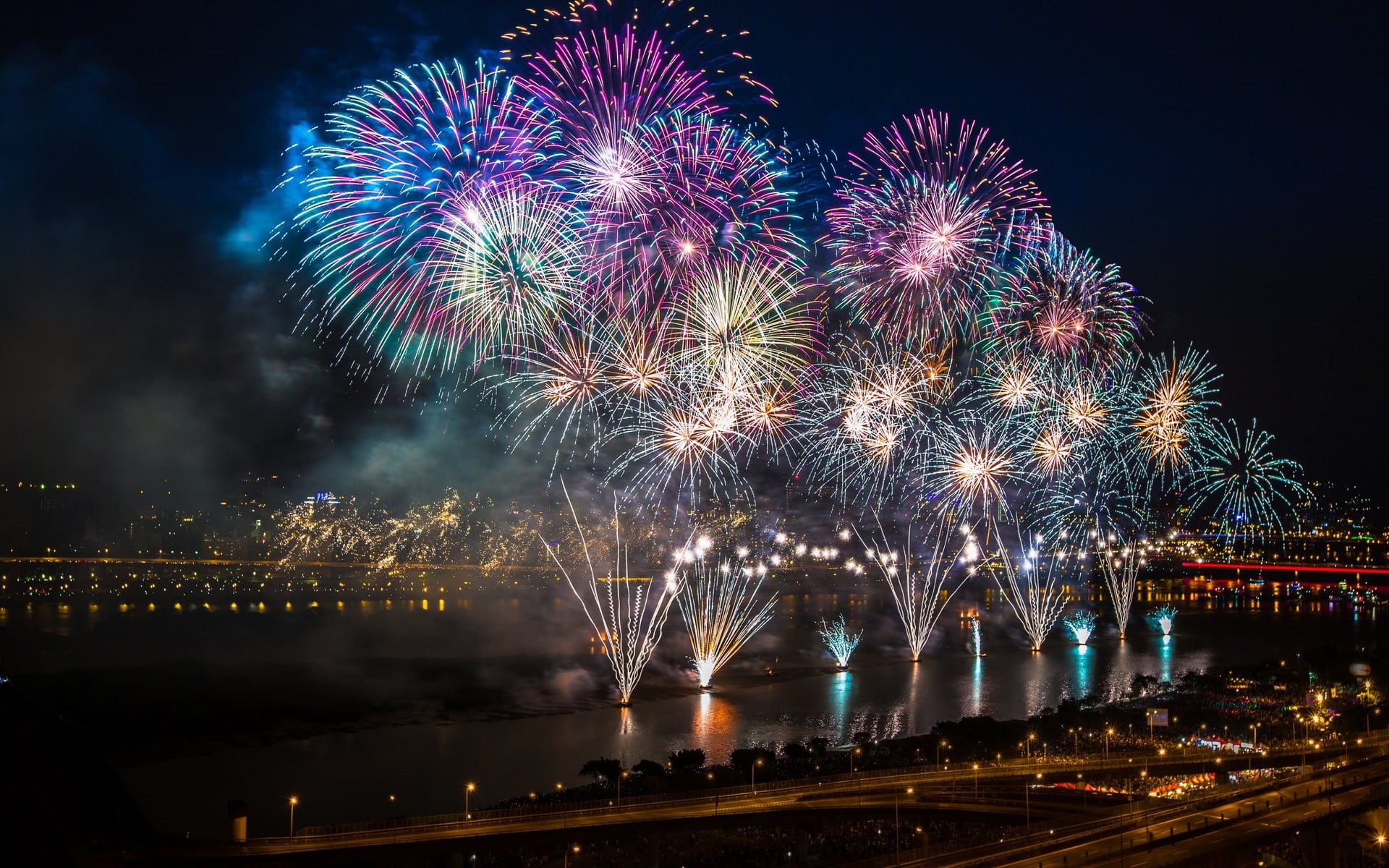 multicolored, building exterior, colorful, 1080P, fireworks, cityscape, glowing, city, night, built structure, outdoors, sky, bridge, firework, blurred motion, HD Wallpaper