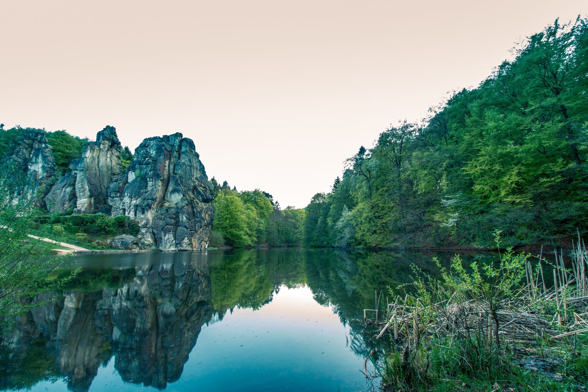 germanic, symmetry, tranquil scene, popular, culture, sanctuary, teutoburg forest, sandstone rocks, waterfront, non-urban scene, stone, water, sky, body, HD Wallpaper