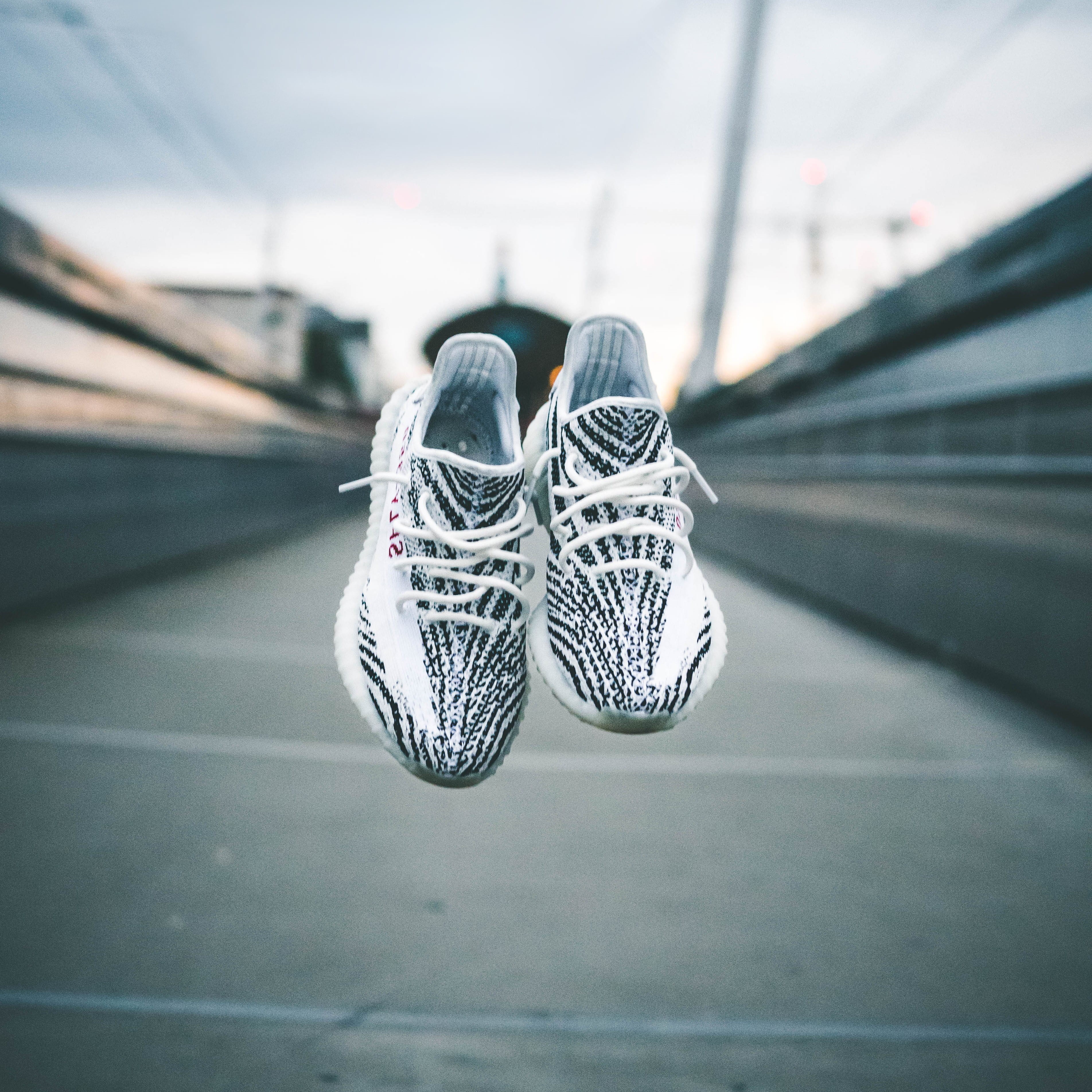 concrete, shallow, selective focus, nike, no people, path, yeezy, mode of transportation, close-up, adidas, absence, pair, urban, bridge - man made structure, Phone HD Wallpaper