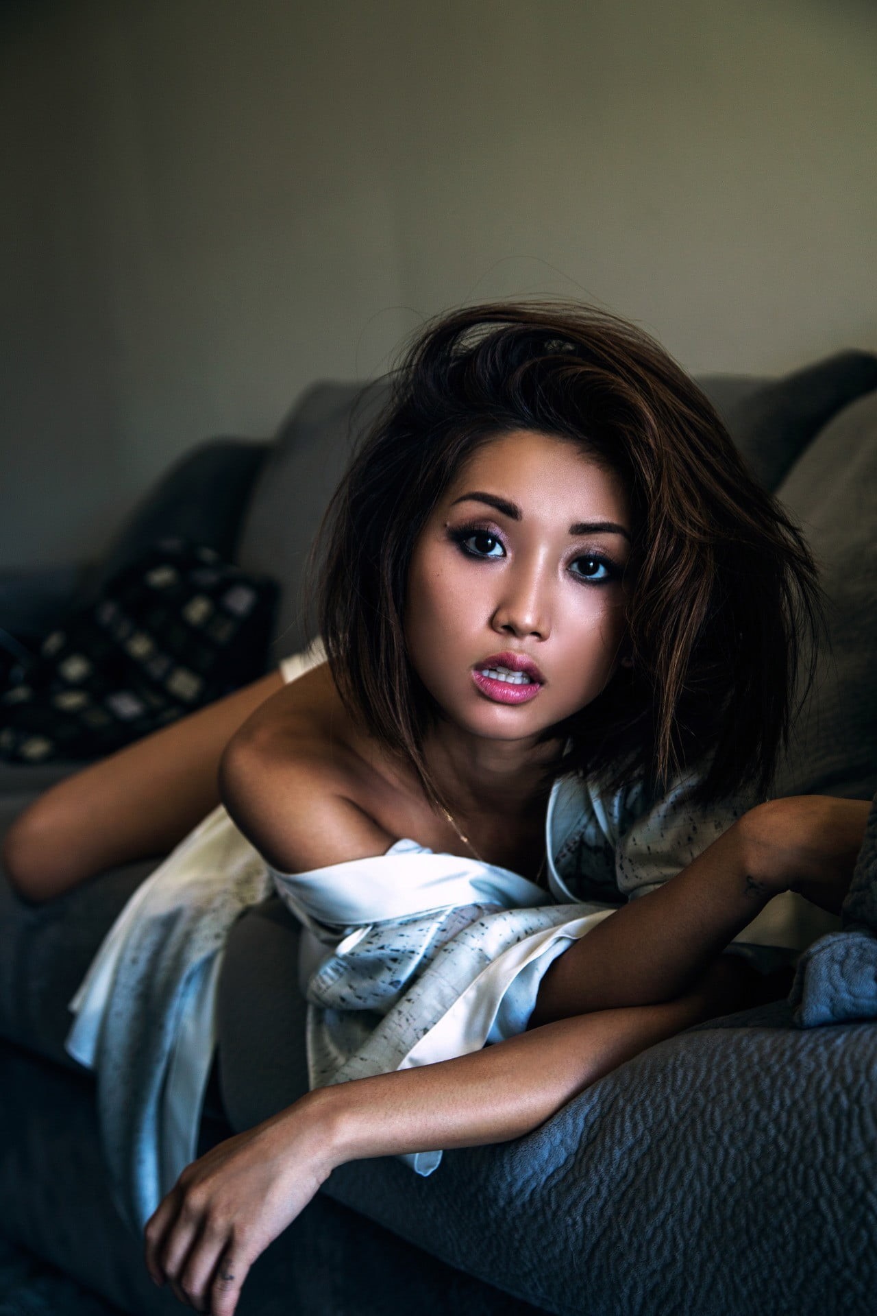 portrait display, sofa, long hair, hair, beauty, body part, adult, brunette, Brenda Song, young adult, pillow, sitting, beautiful people, bare shoulders, Phone HD Wallpaper
