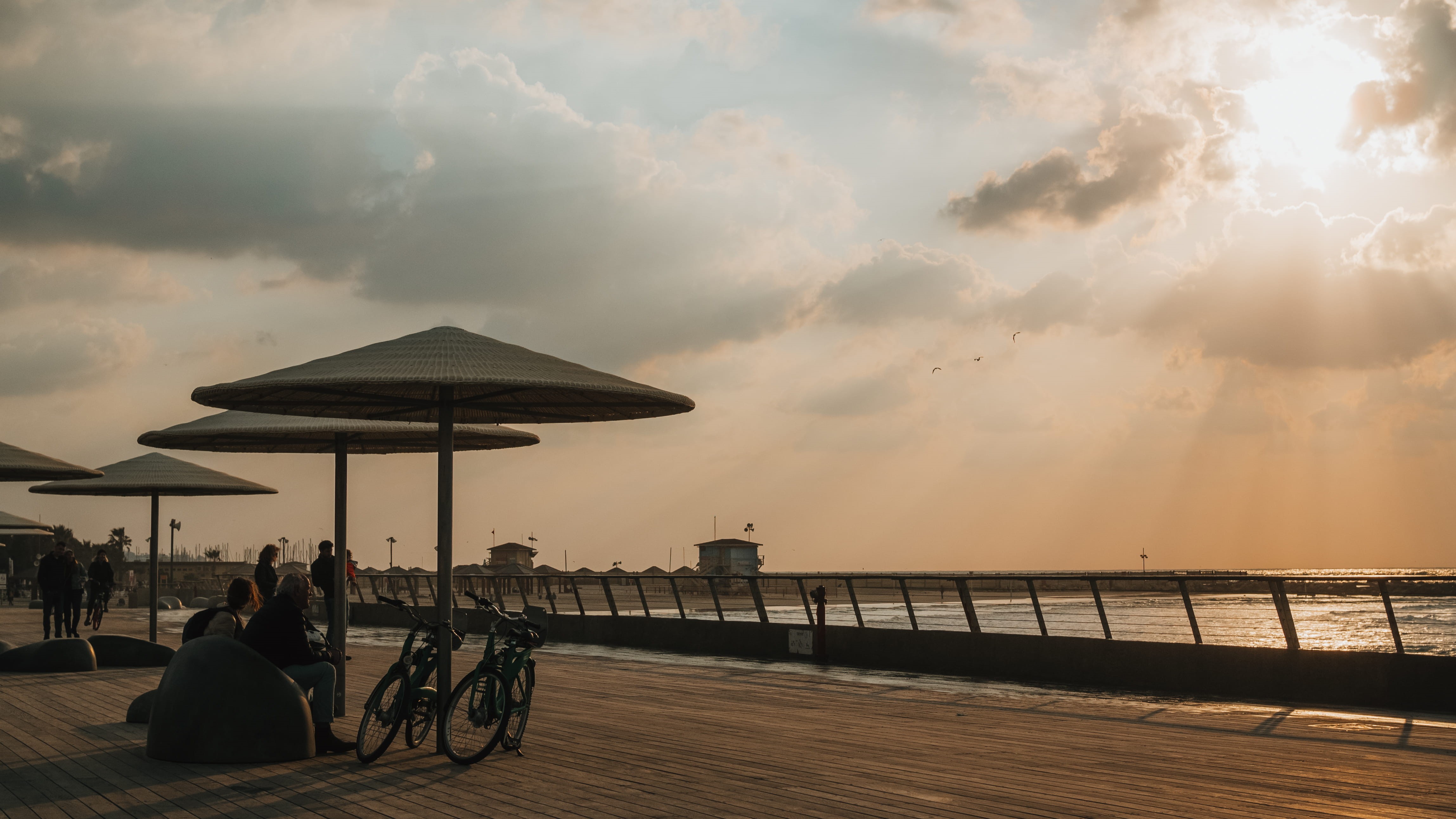 sunset, adult, sitting, architecture, tel aviv, israel, women, lifestyles, water, beach, seat, leisure activity, nature, 4K, horizon over water, people, HD Wallpaper