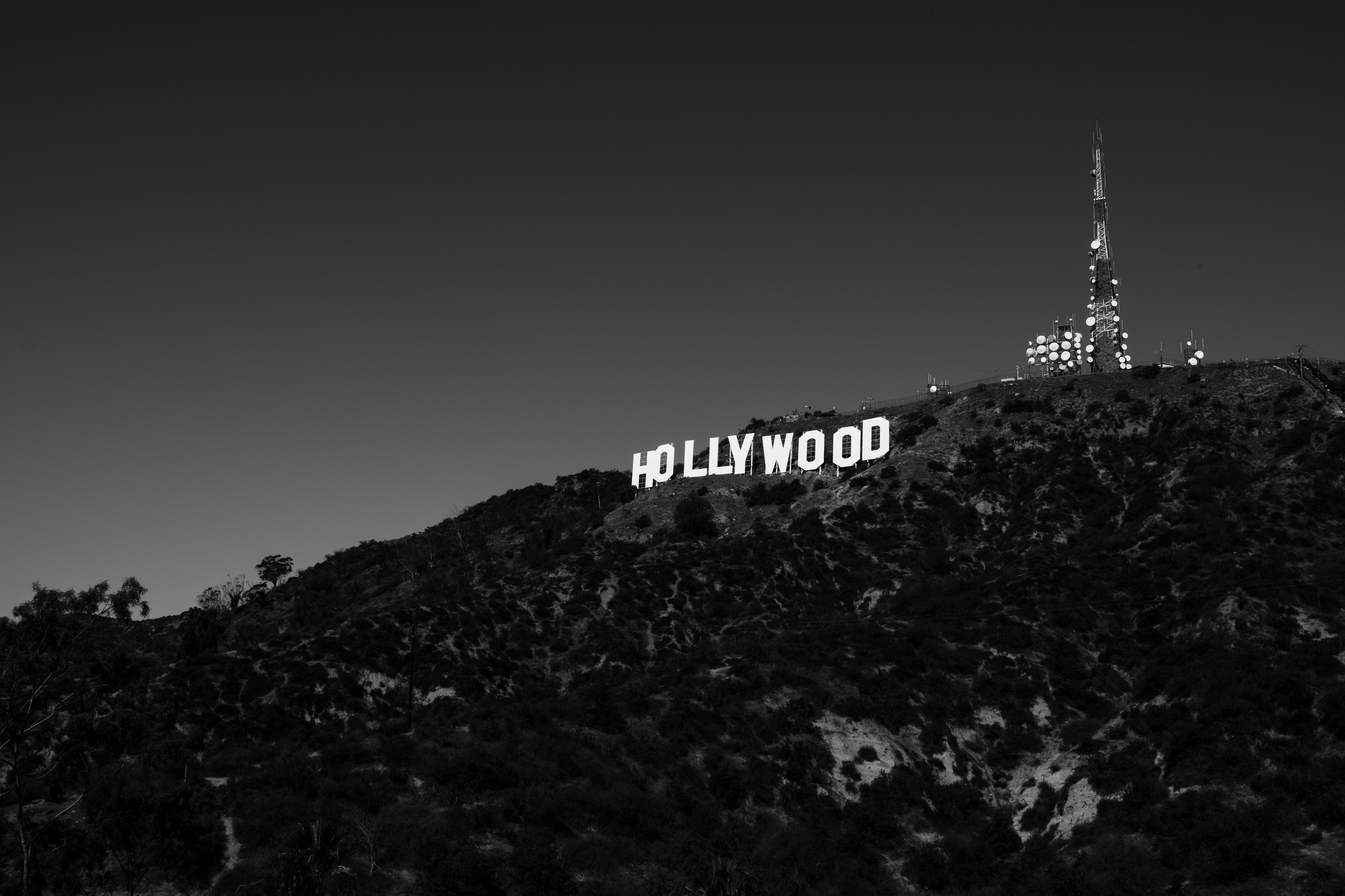 photography, signage, outdoors, highland, hollywood, clear sky, architecture, sky, black and white, western script, low angle view, tree, building exterior, HD Wallpaper