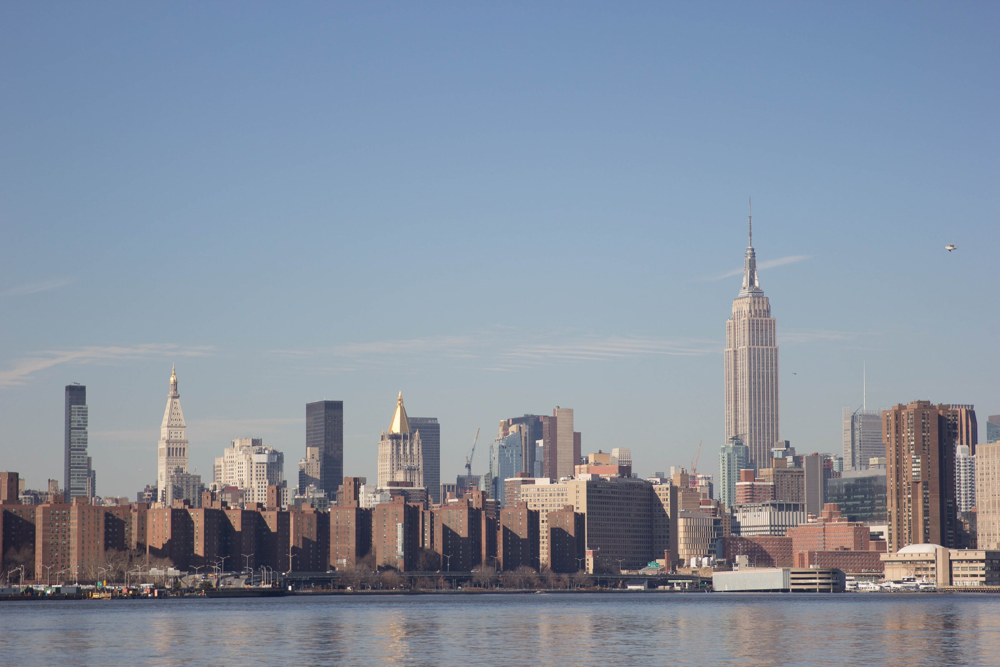 urban skyline, urban, daytime, city, waterfront, built structure, tower, sky, spire, cityscape, america, usa, 2K, finance, nyc, new york city, water, landscape, HD Wallpaper