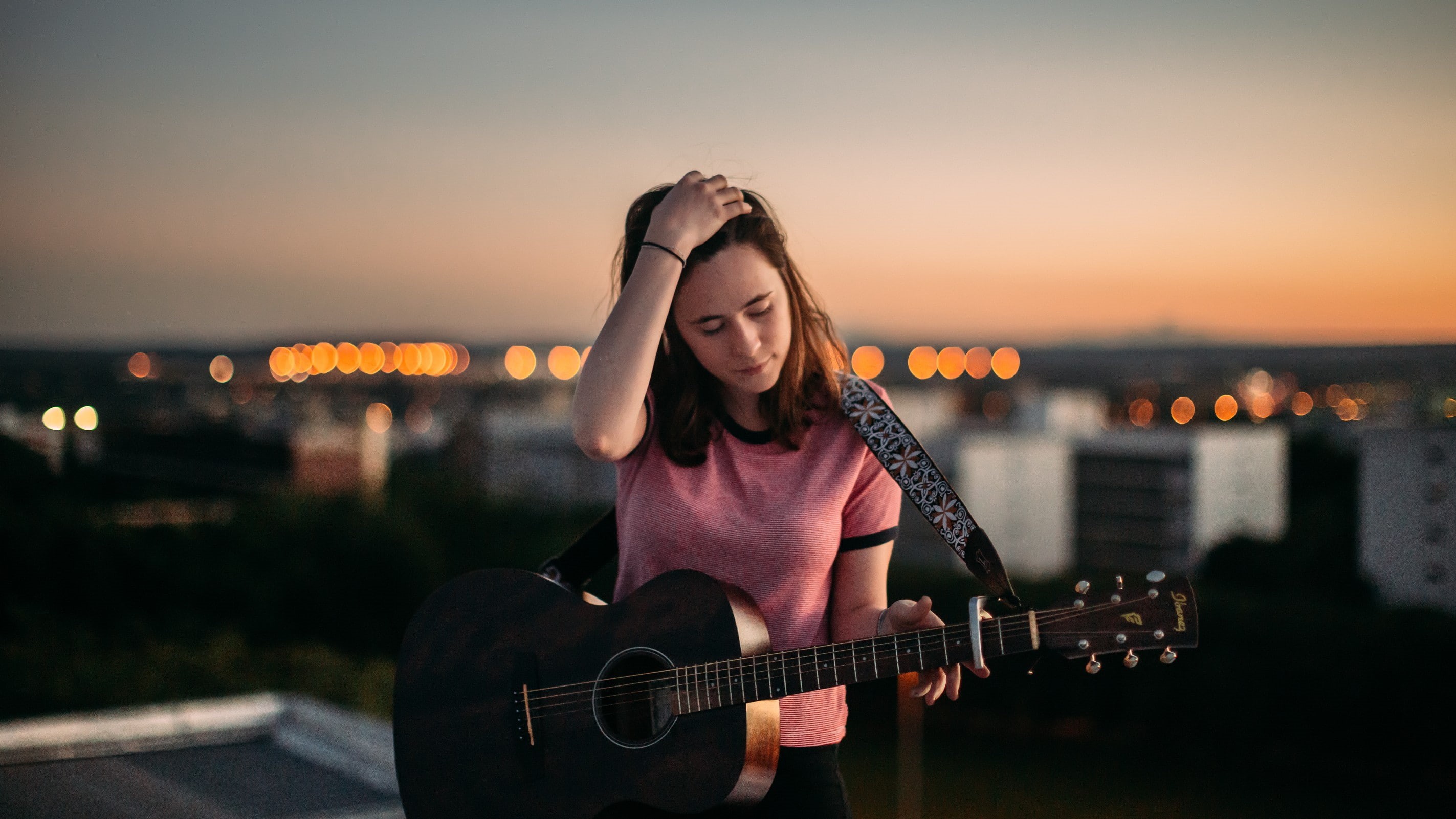 architecture, city, casual clothing, adult, acoustic guitar, guitarist, sky, 2K, one person, women, guitar, focus on foreground, music, young adult, sunset, HD Wallpaper