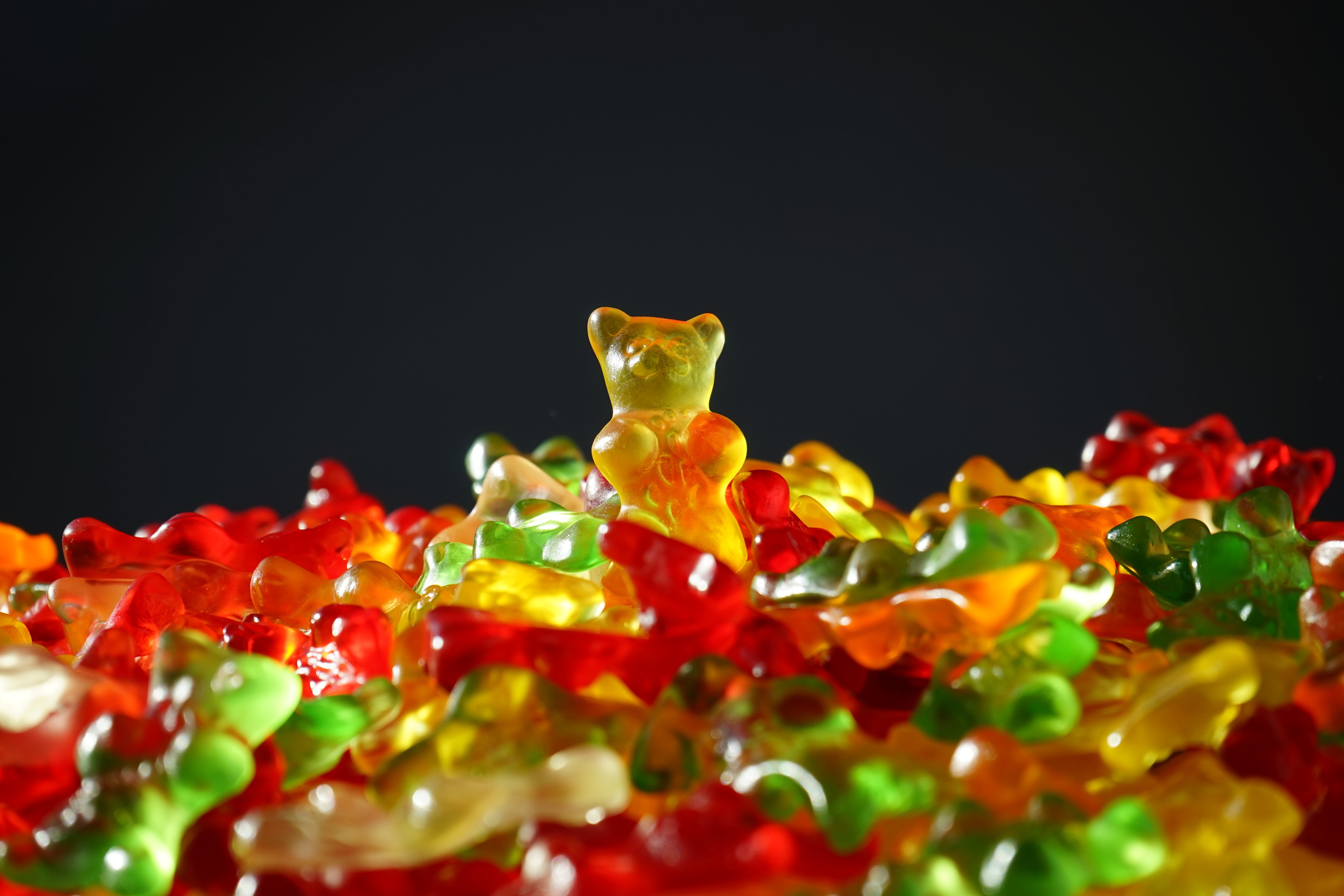 vegetable, still life, yellow, red, bear, delicious, winner, animal representation, sweet, focus, gold bear, selective focus, close-up, white, food, black background, HD Wallpaper