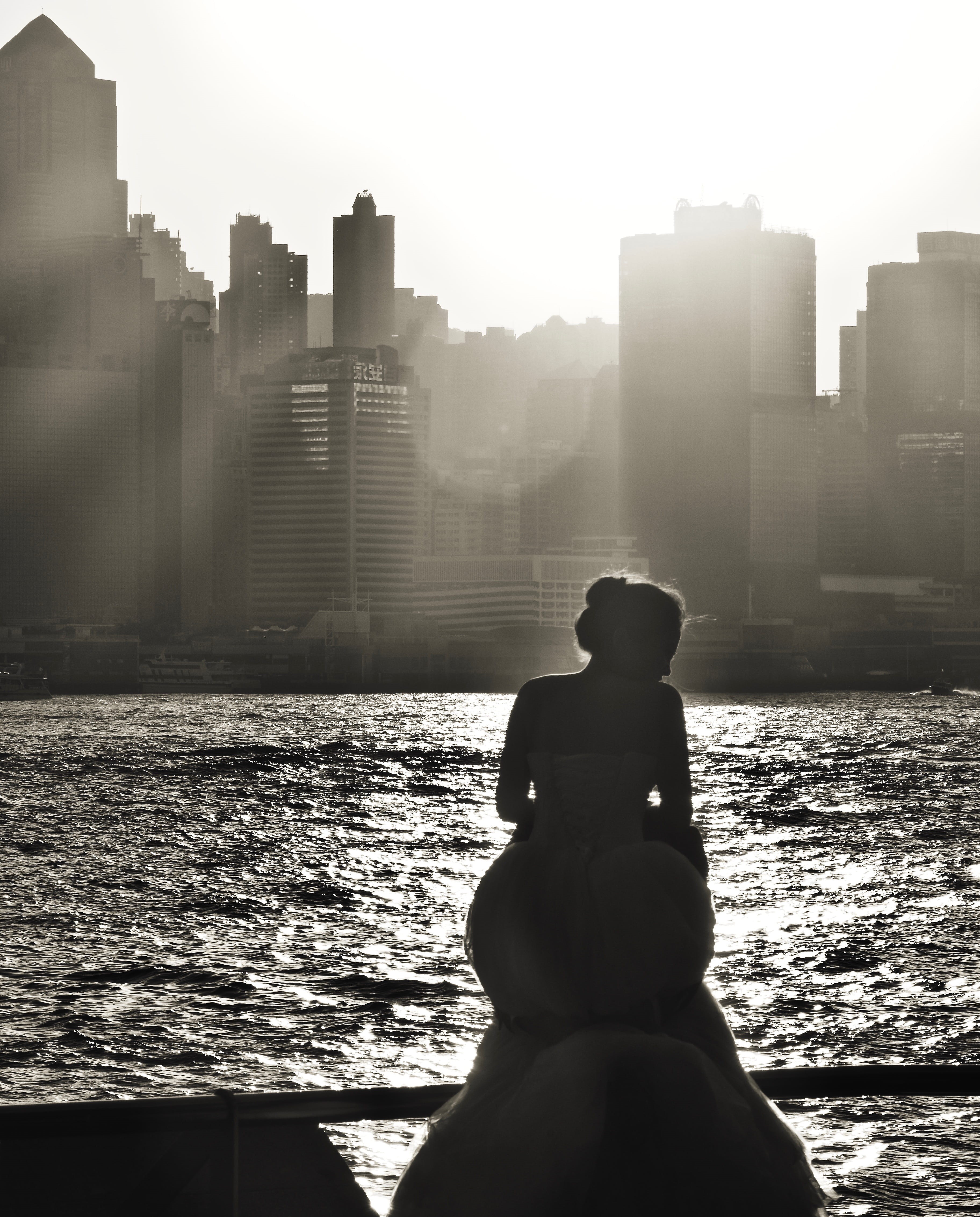 lens flare, lifestyles, one person, water, outdoors, built structure, 4K, building exterior, men, building, architecture, day, kowloon public pier, sitting, Phone HD Wallpaper