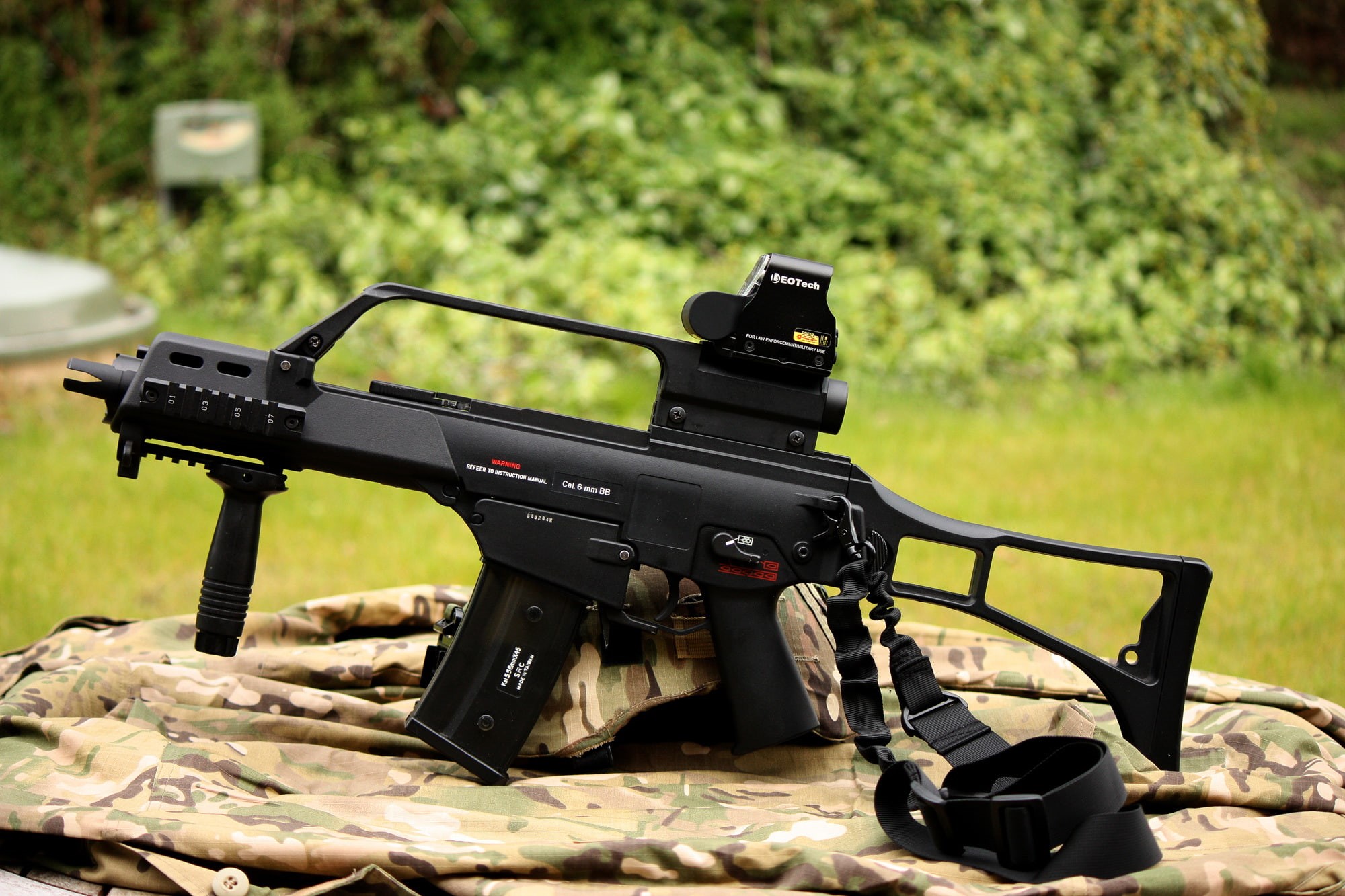 field, nature, sunlight, machine, HK G36C, weapons, focus on foreground, black color, plant, communication, green color, no people, camera - photographic equipment, HD Wallpaper