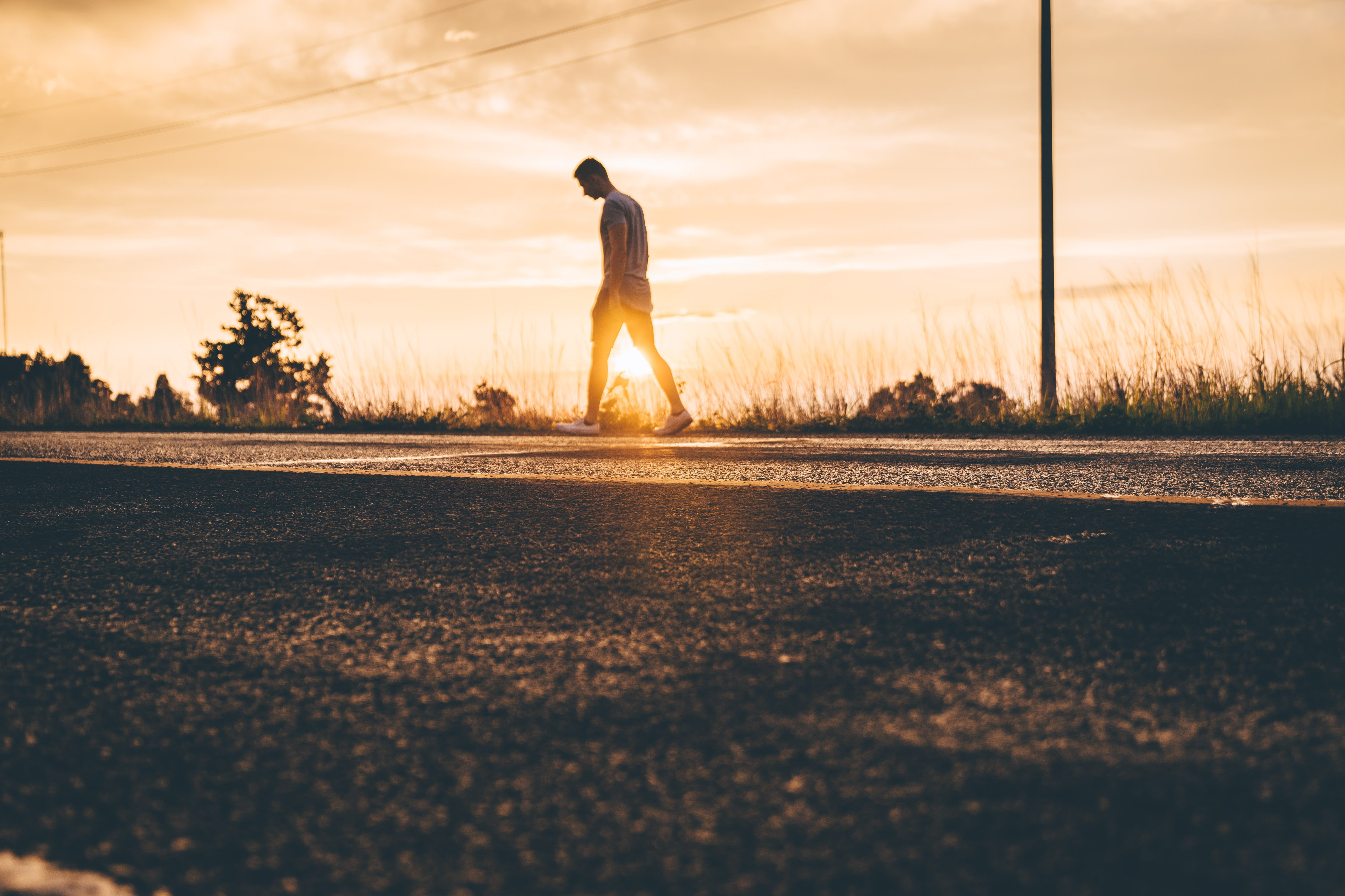 leisure activity, 5K, sunset, sunrise, standing, men, human, surface level, road, adult, man, leading, one person, full length, sunlight, asphalt, pathway, HD Wallpaper